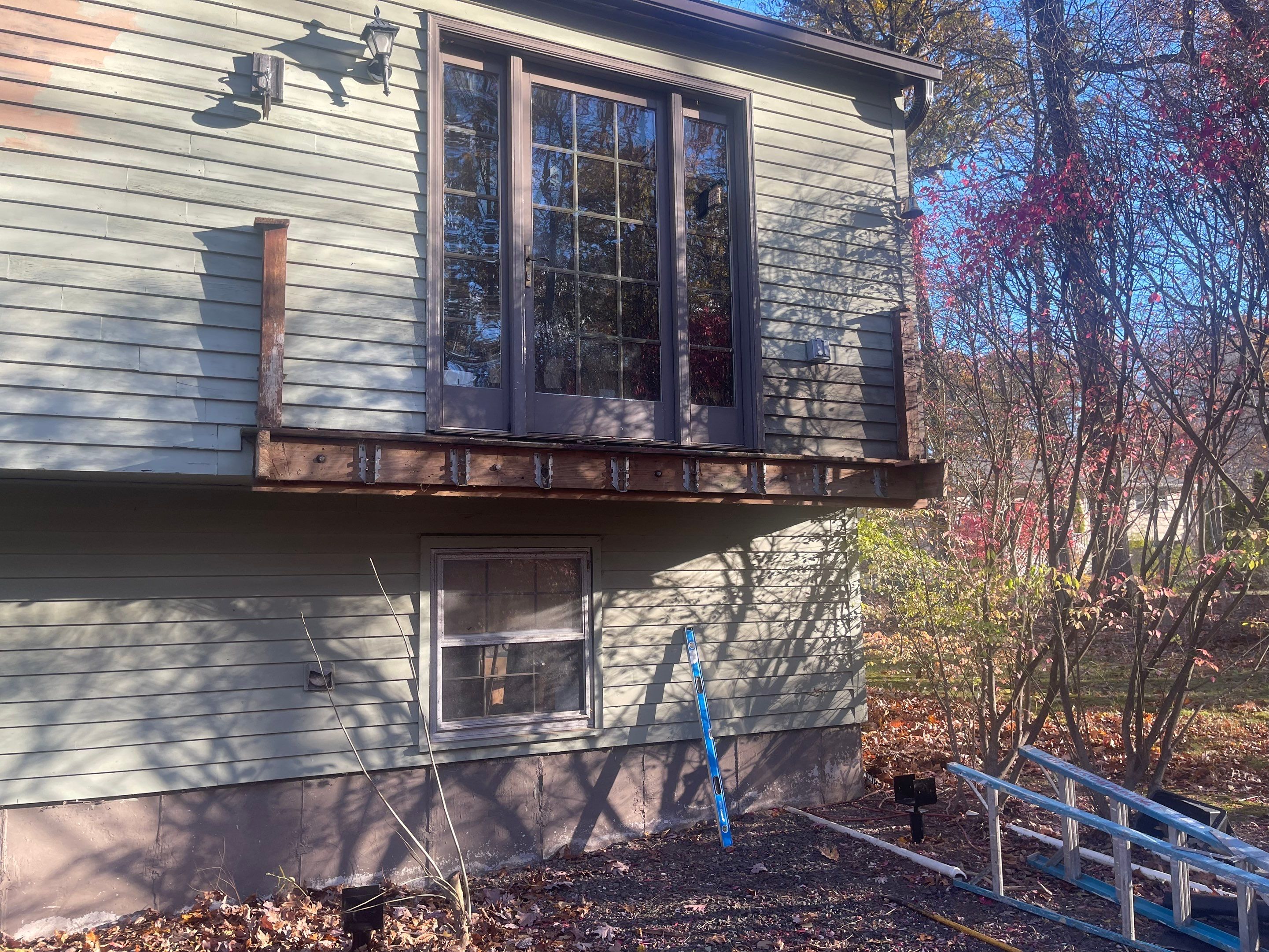 Replacement deck with Trex Tropical Tiki torch and Transcend Cocktail railings in vintage lantern. by DiGiorgi Roofing and Siding Inc