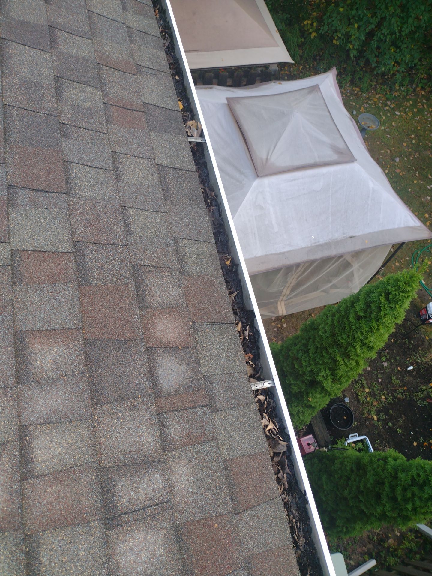 Commercial gutter cleaning Traverse City, MI before photo with filled gutters