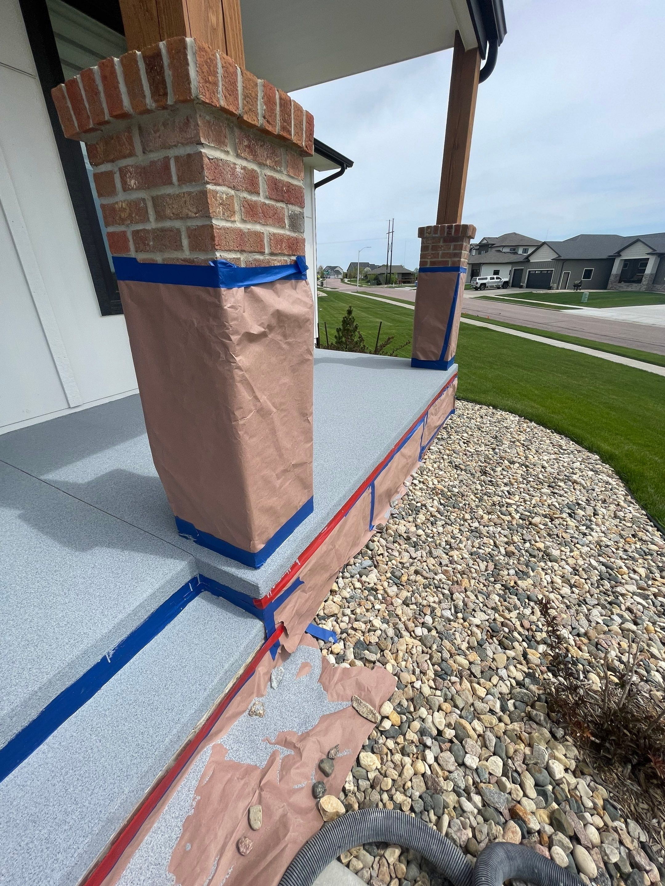 Grey Speckled Concrete Porch Coating for Sioux Falls Home by Select Painting, Coatings & Garage Cabinets
