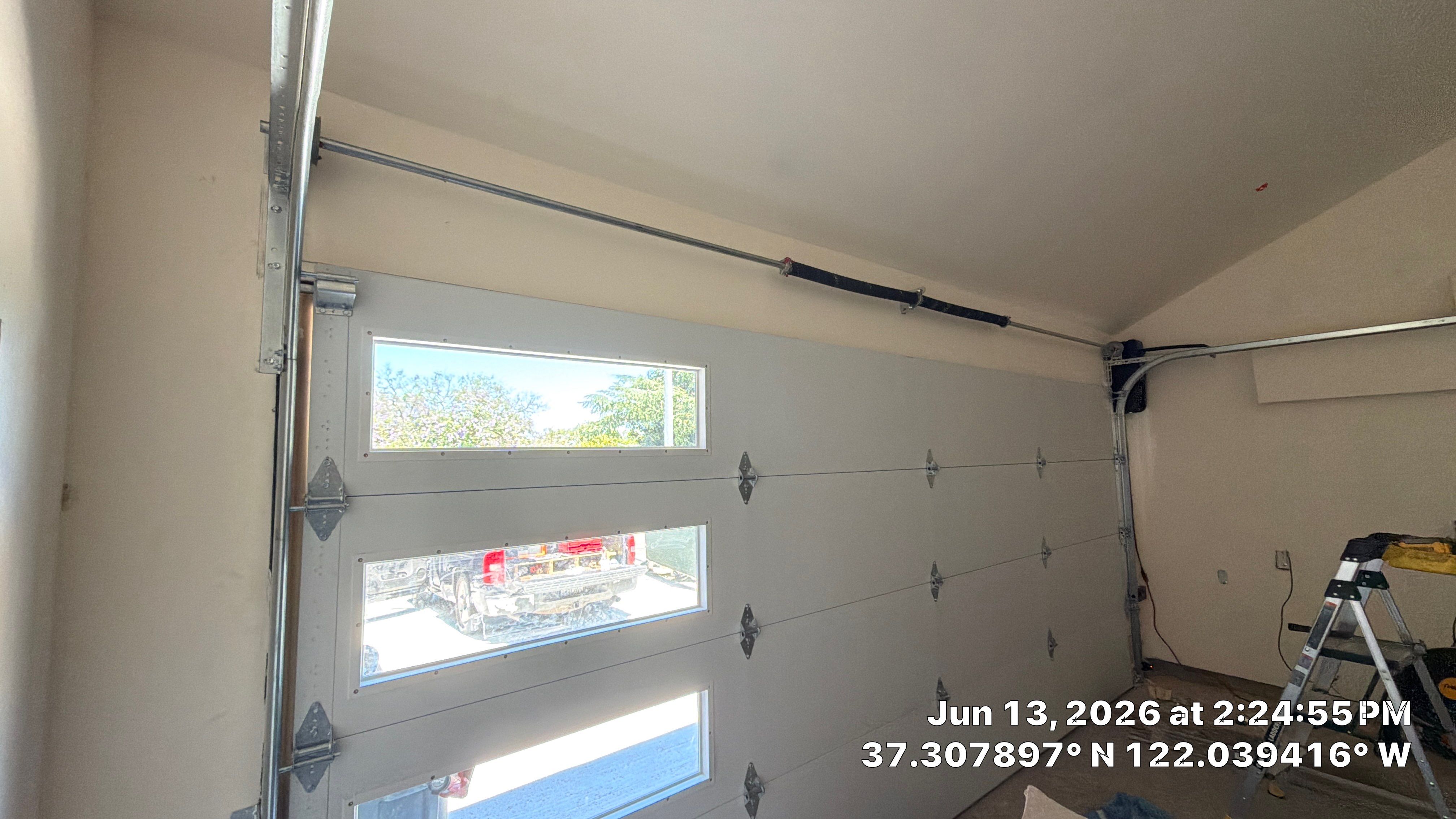 Modern Black Garage Door Installation With Vertical Windows In Cupertino by Valiant Garage Door LLC