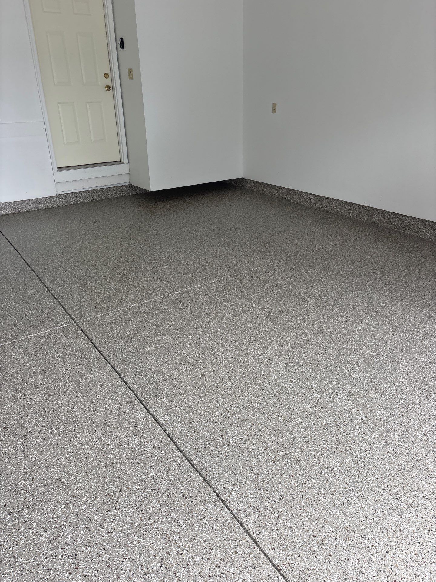Garage floor in Holt using Smoke Flake by Freedom Concrete Coatings. 
