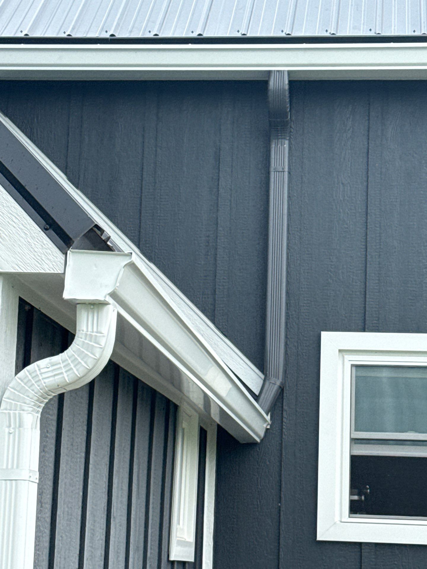 Seamless Gutter and Gutter Helmet Installation on Bellaire Metal Roof by Rainbow Seamless Systems