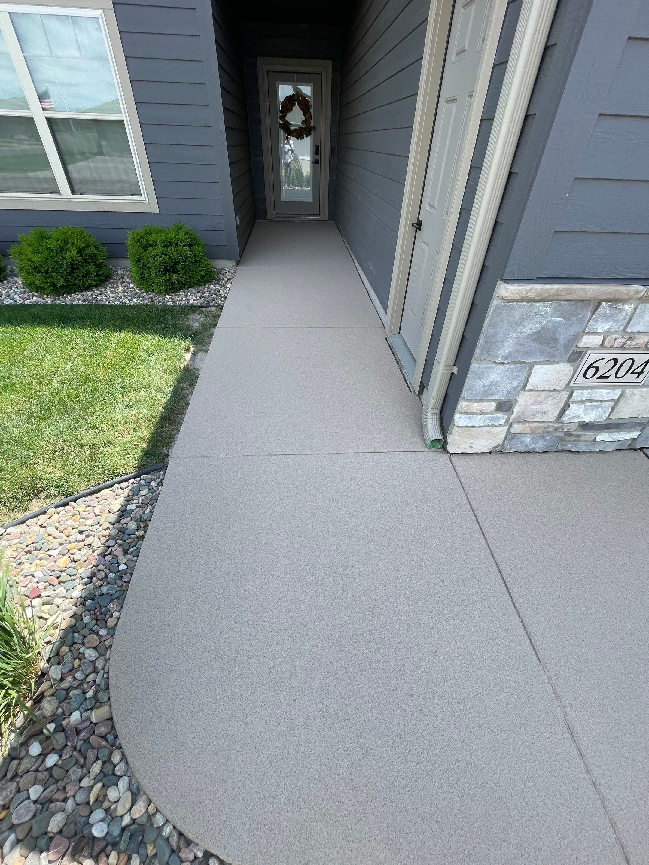 Textured Concrete Patio Coating and Custom Privacy Pergola in Sioux Falls by Select Painting, Coatings & Garage Cabinets