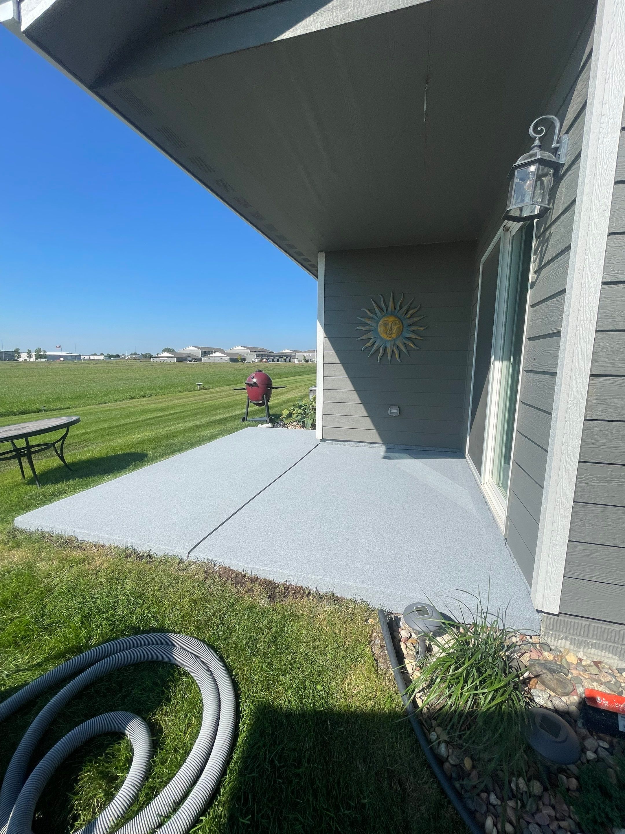 Starry Evening Concrete Patio Coating Installation in Tea by Select Painting, Coatings & Garage Cabinets