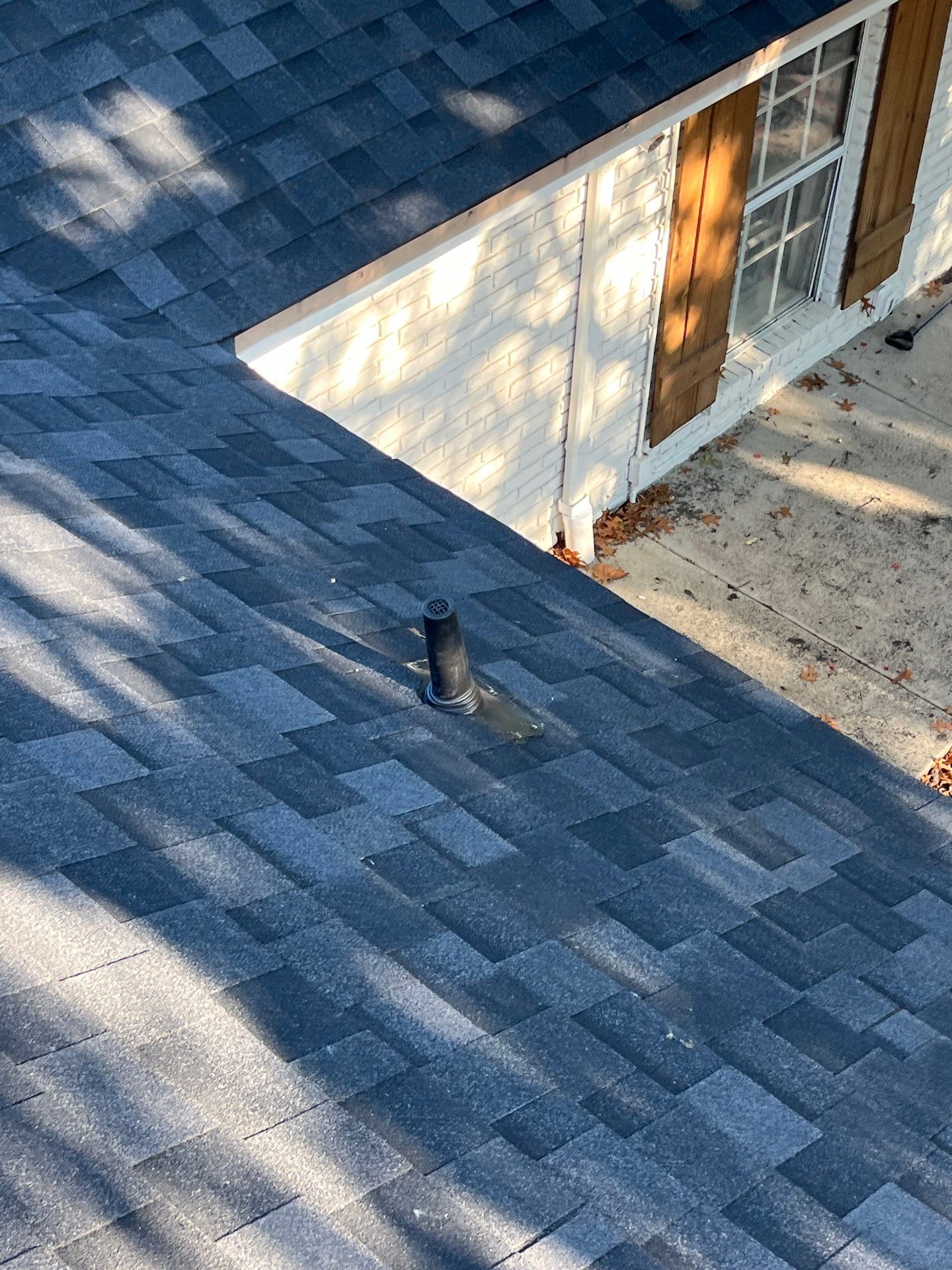 White brick with IKO Granite Black by Tejas Roofworks + Restoration