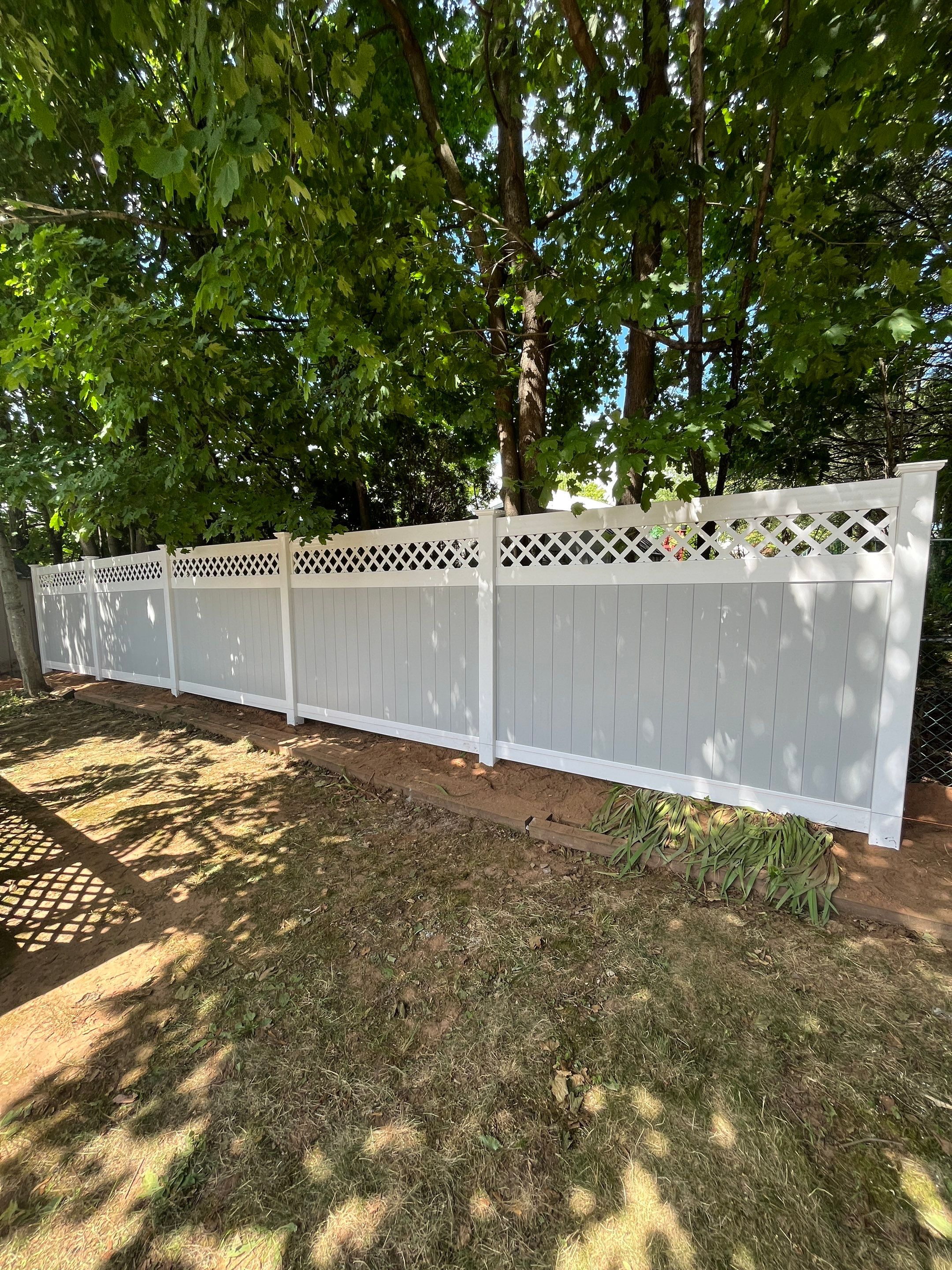 Vinyl privacy fence, Decorative lattice top. Two toned coloring White and Gray by DiGiorgi Roofing and Siding Inc