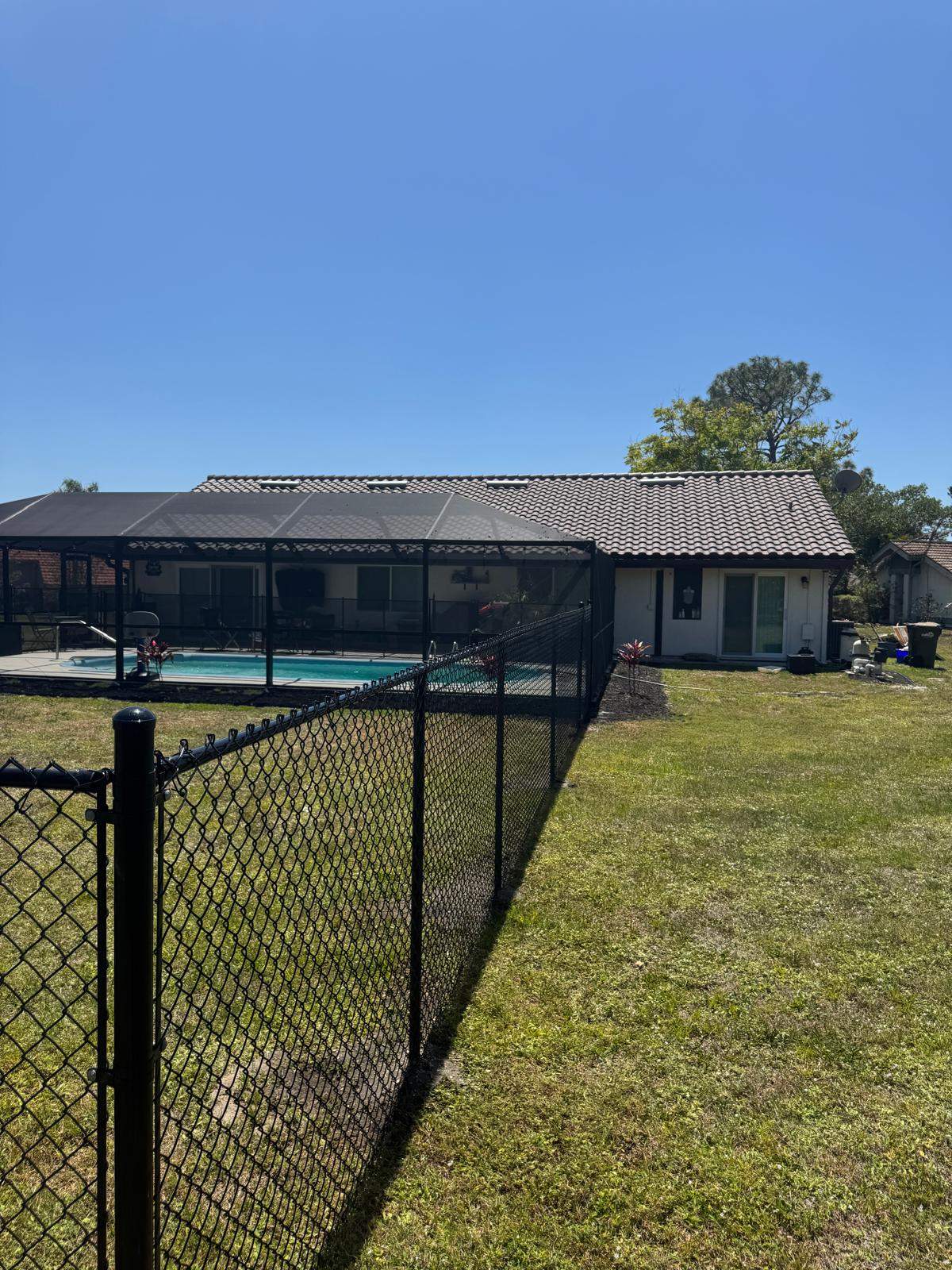 Black Chain Link Residential Backyard Fence Installation in North Port by True Fence LLC