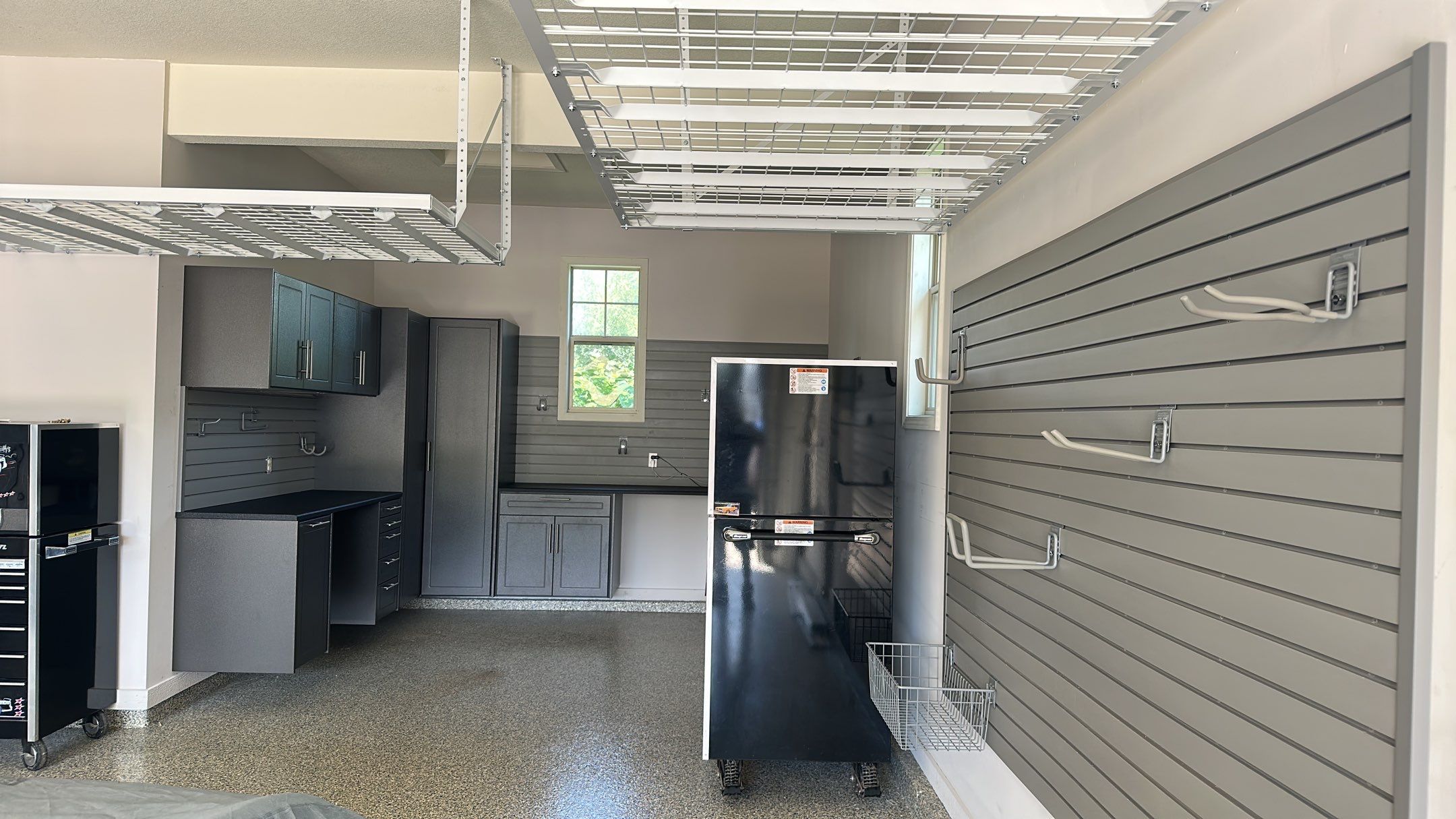Lori H. upgrade her garage with cabinets and overhead racks by Banner Garage