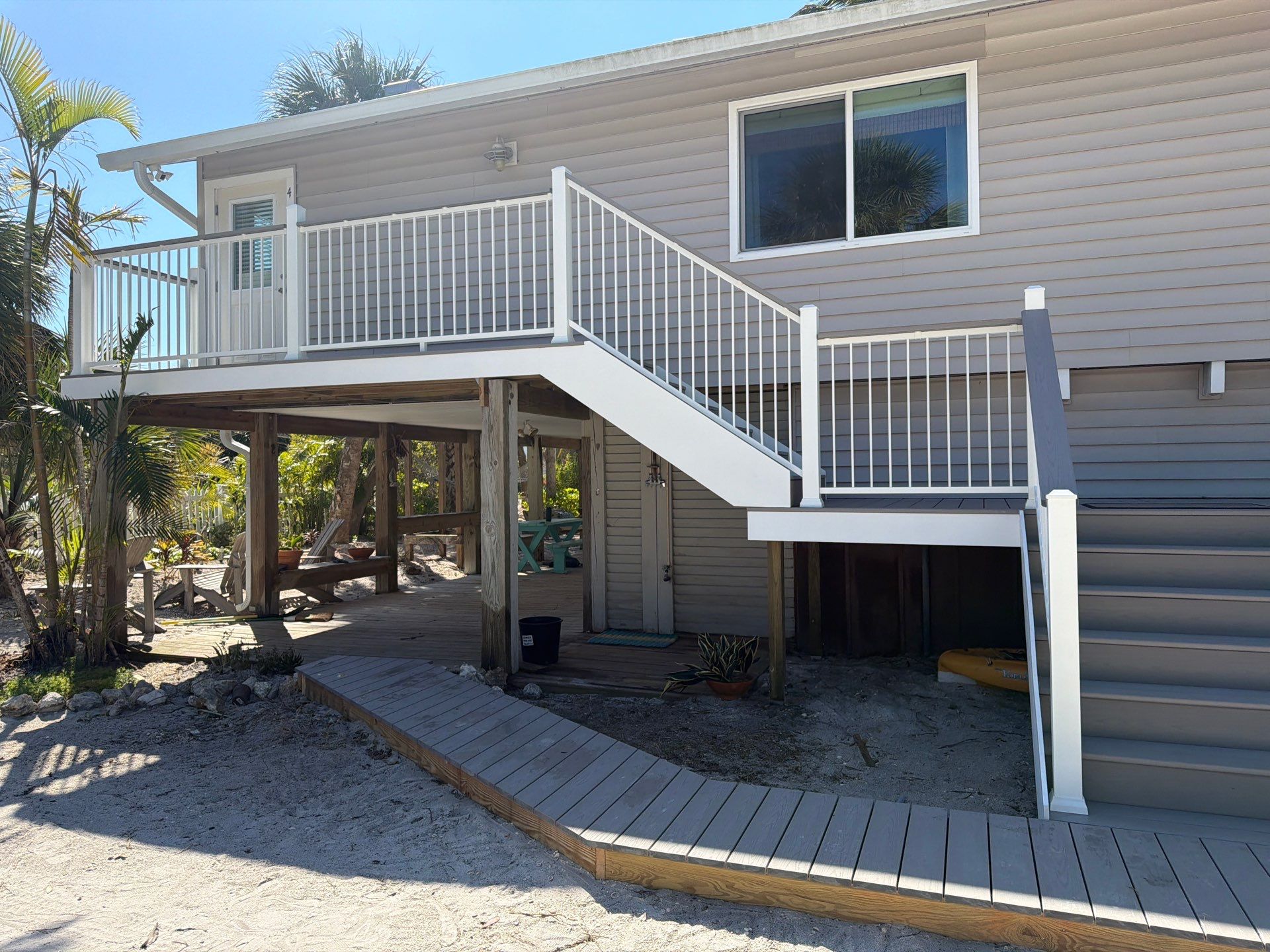 Elevated Coastal Home Renovation with Siding and Custom Decks in Englewood by Smirnov Construction Inc