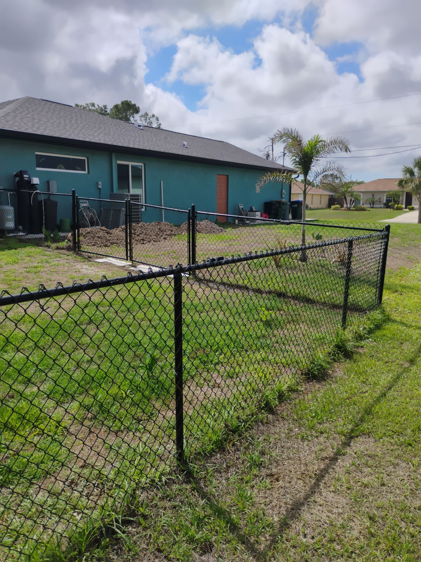Black Vinyl-Coated Chain Link Fence and Rolling Gate Installation in North Port by True Fence LLC