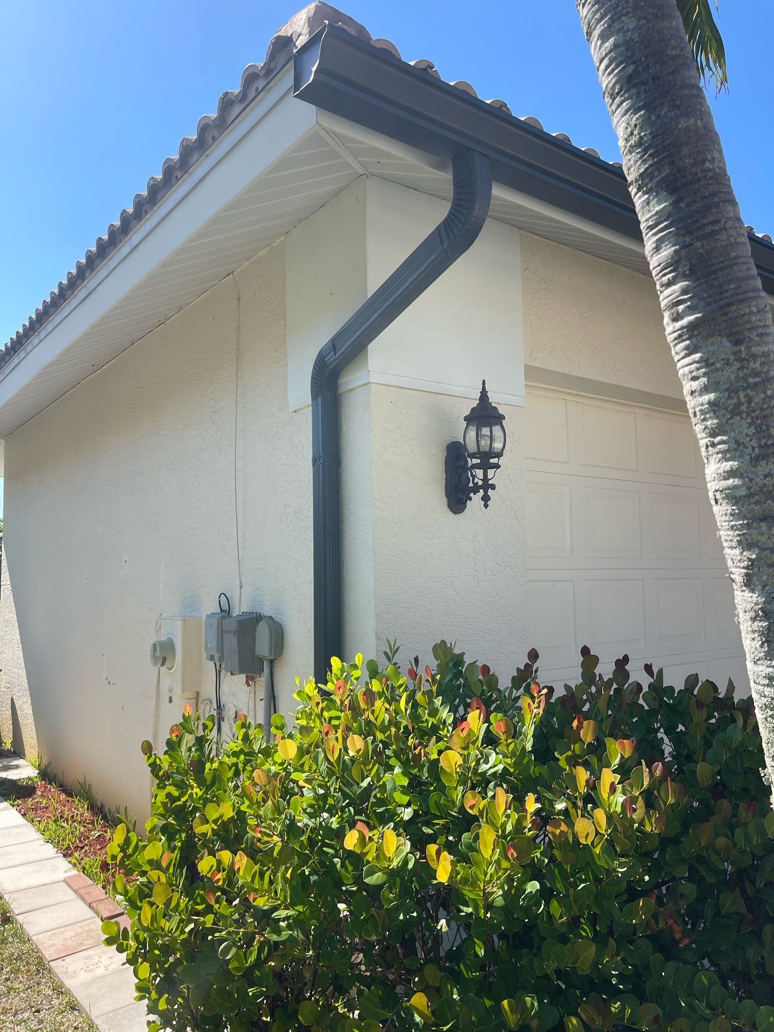 Bronze Seamless Gutters using 3X4 Elbow Downspout in Bonita Springs FL by Gutter Professors