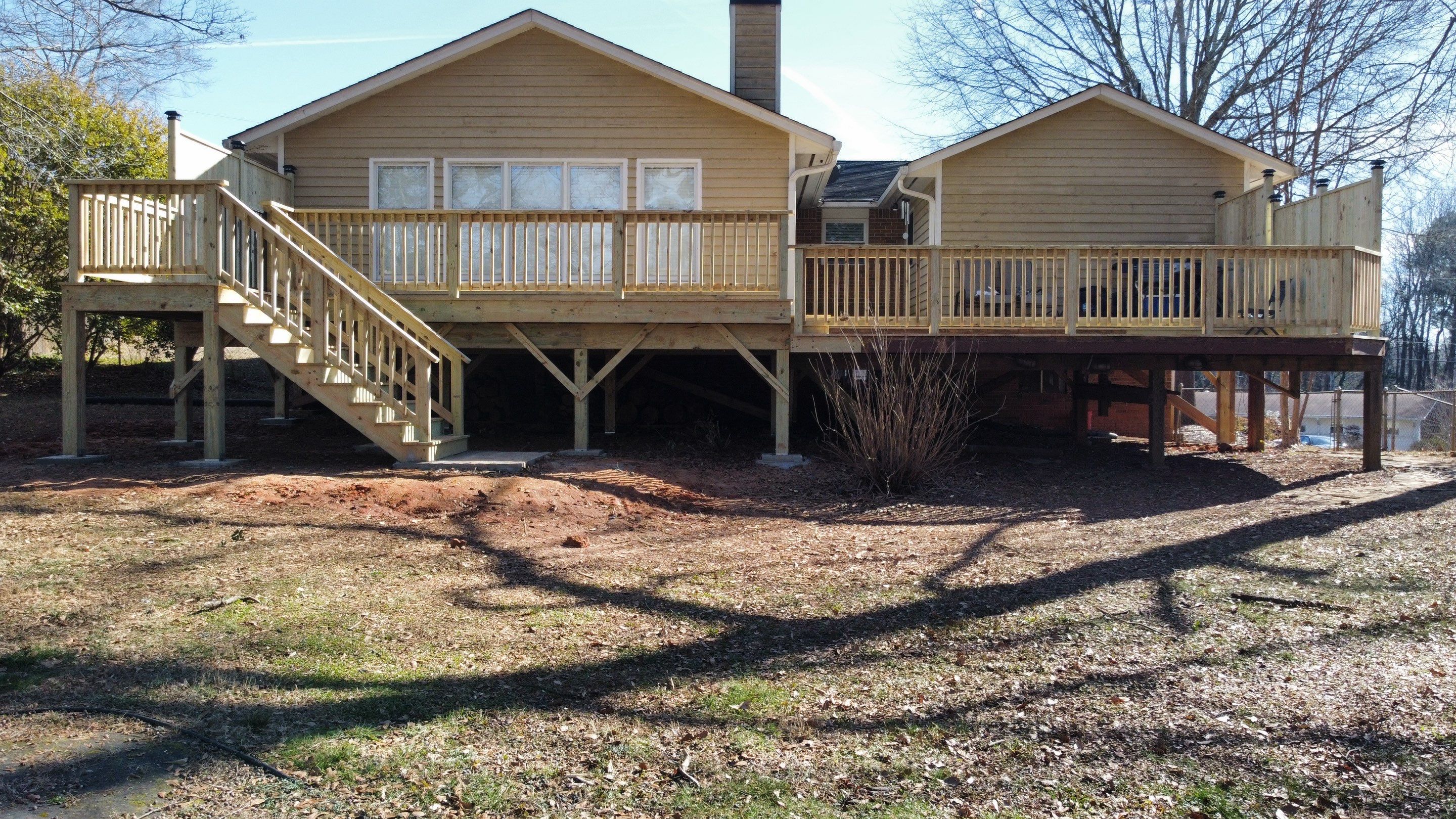 Elevated Pressure-Treated Wood Deck Extension in Marietta by Swift Home Renovations