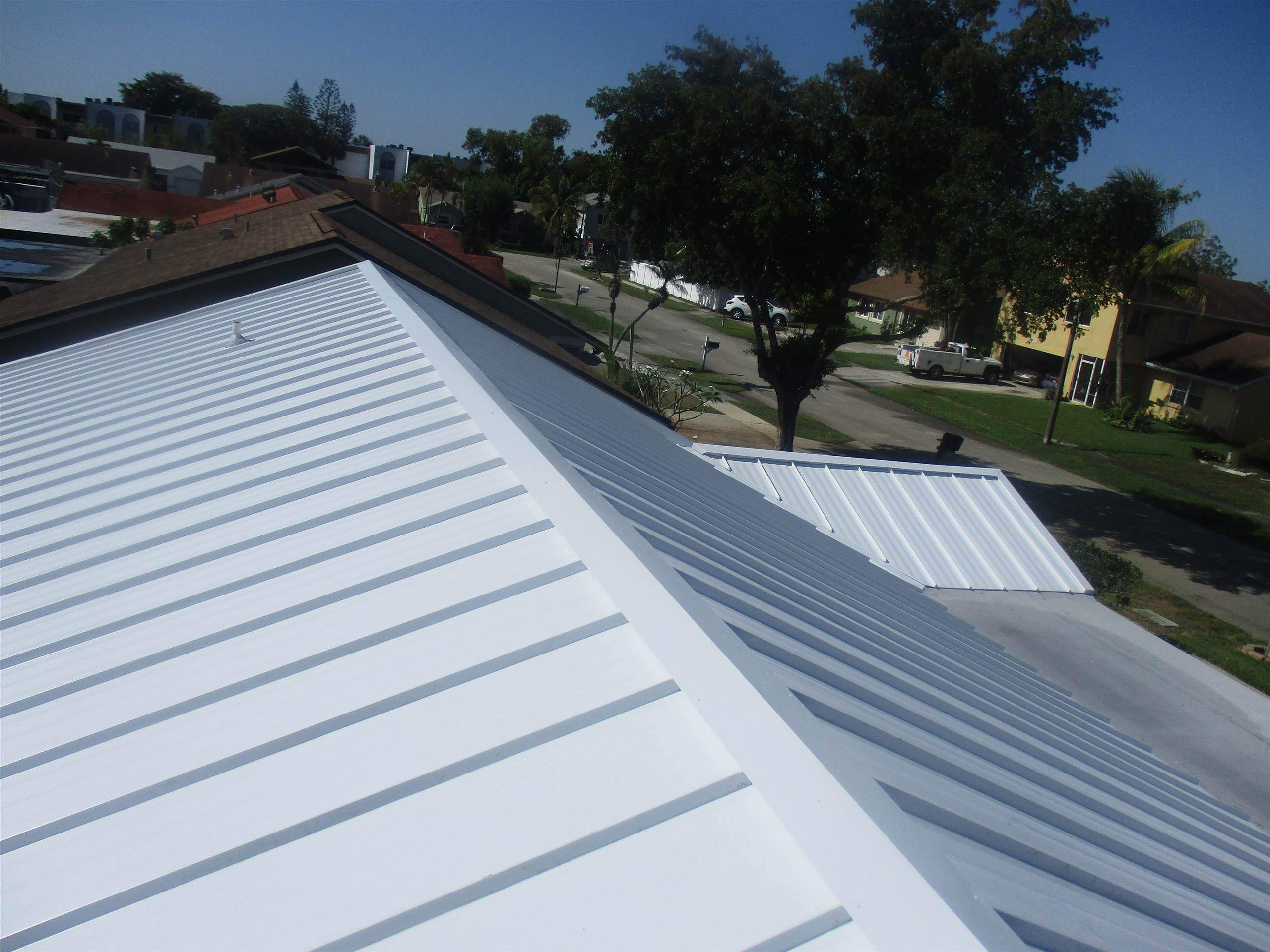 Standing Seam Metal & Flat Re-Roof using 1.5" Nail Strip 24ga Solar White Kynar Coated Standing Seam Metal Panels by Morton Roofing, Inc.