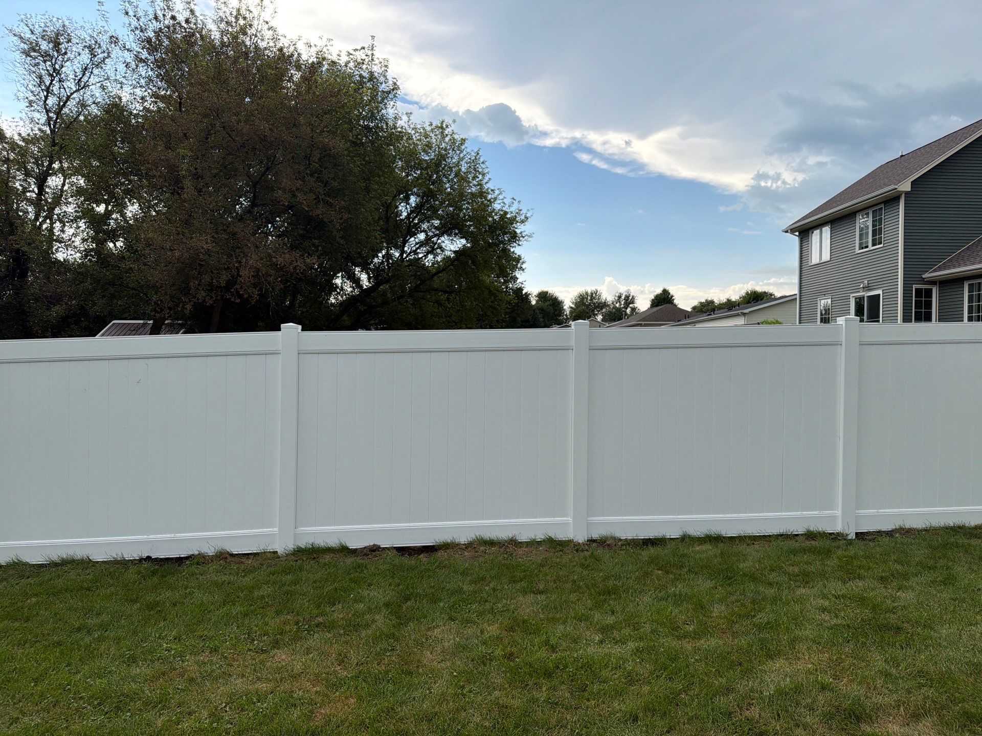White Vinyl Privacy Fence Installation in Raymond, IA by Perfect Picket Fence and Stain