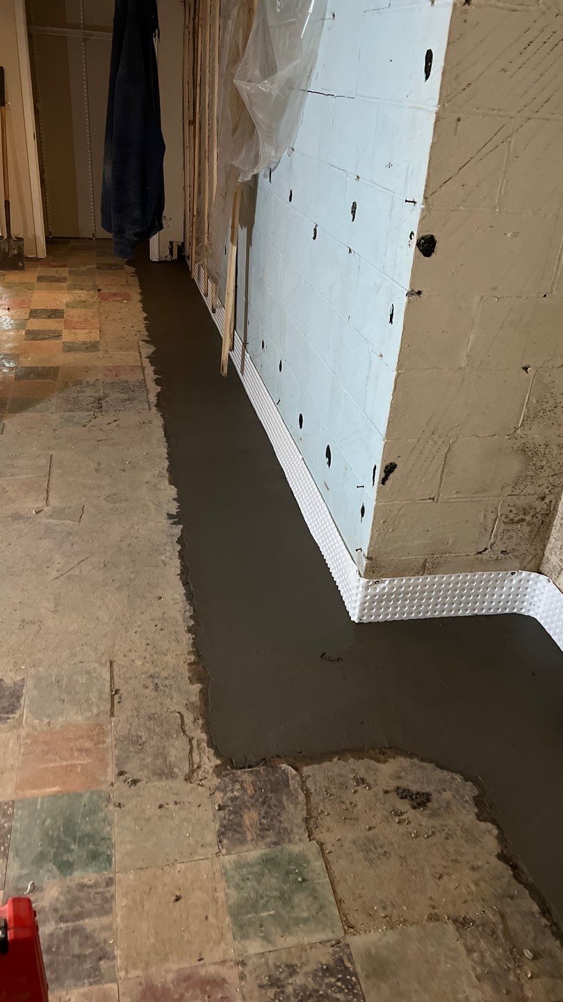 Interior drain tile system installation by ACE Waterproofing & Basement Solutions