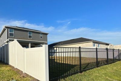 Vinyl Fence Installation using Black 3 Rail Aluminum and Vinyl Privacy Fence 