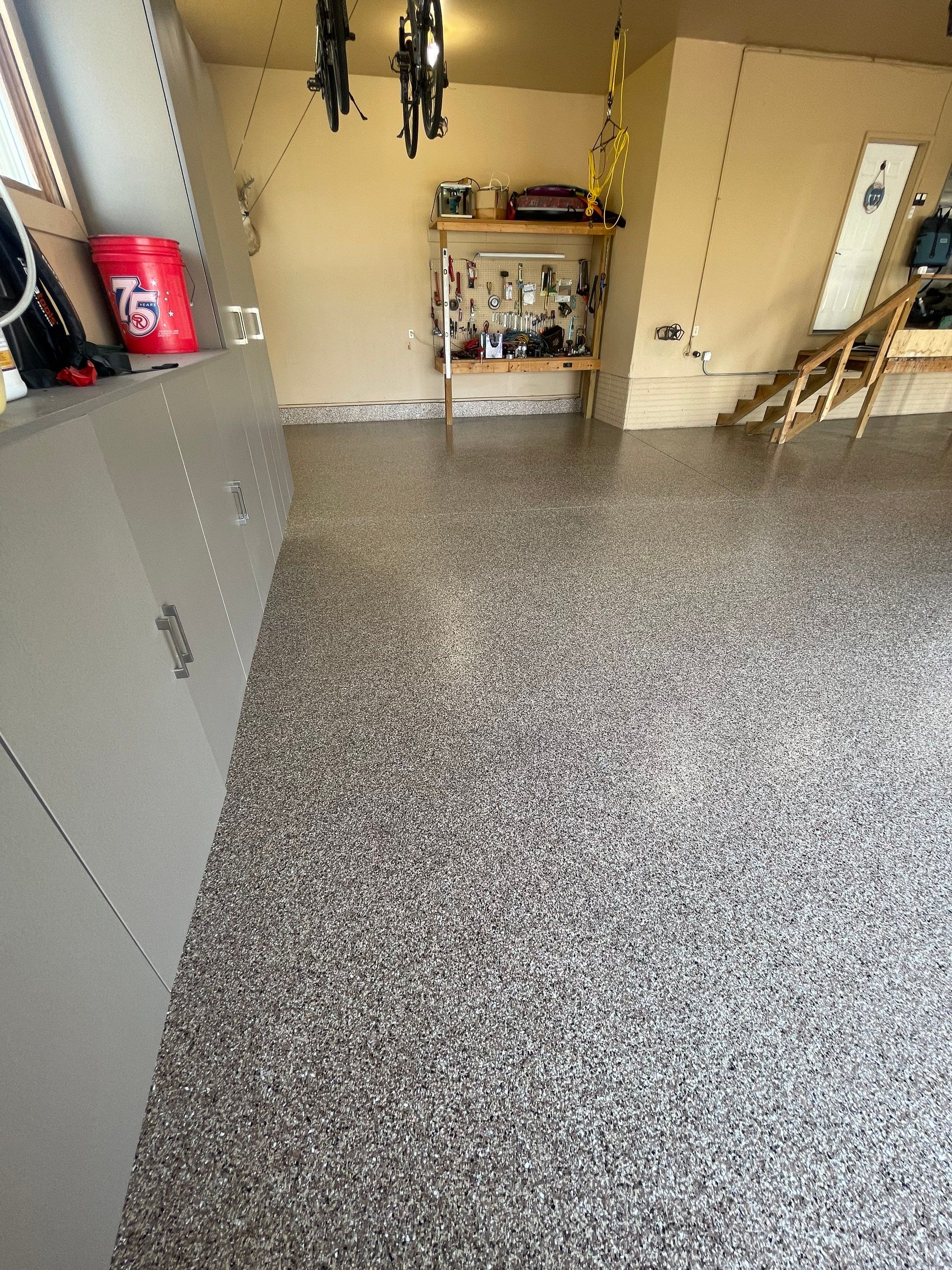 Residential Garage Floor Transformation with Speckled Epoxy Coating by Select Painting, Coatings & Garage Cabinets