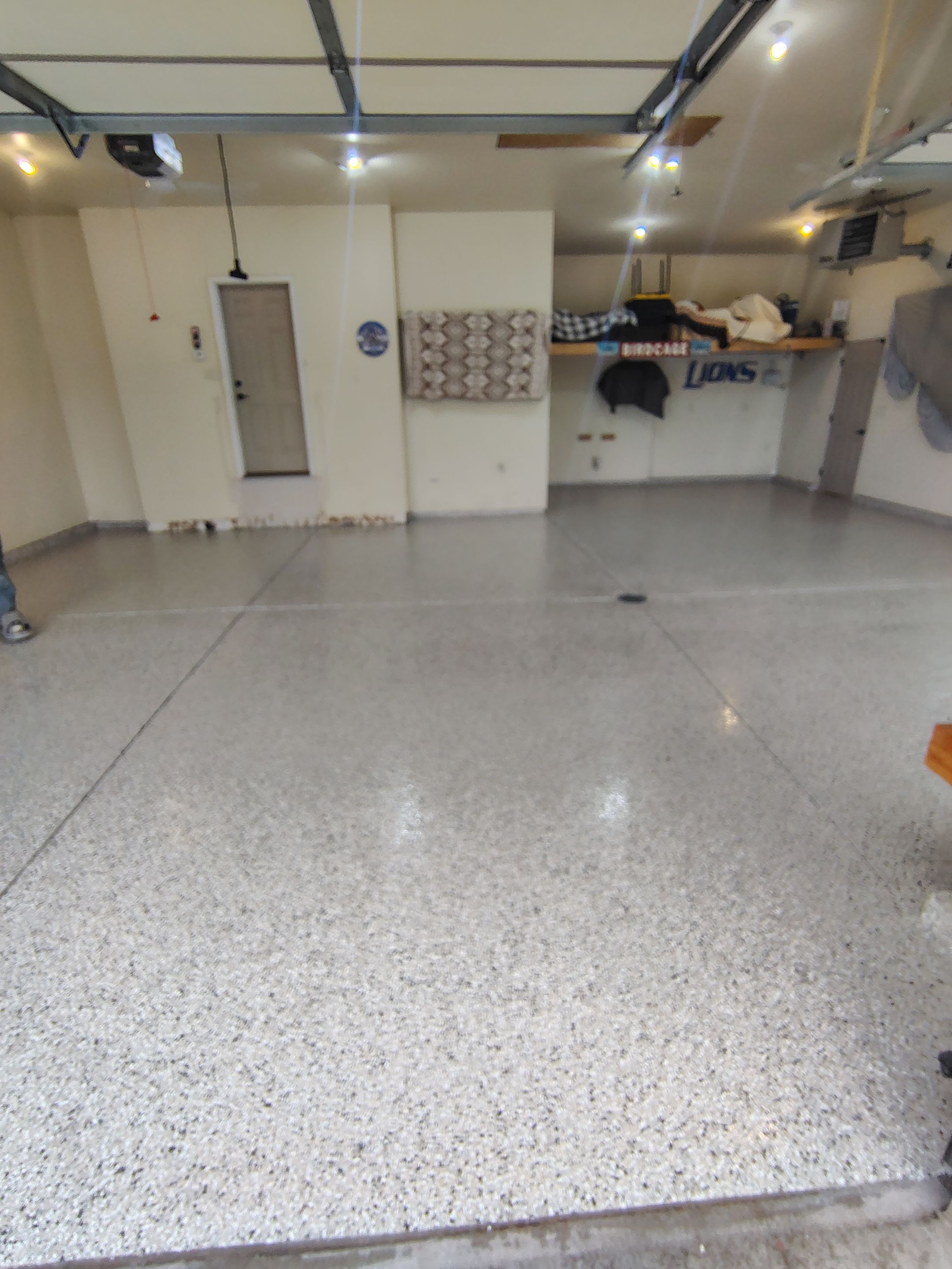 Sioux Falls Garage Floor Repair and Speckled Epoxy Coating Installation by Select Painting, Coatings & Garage Cabinets