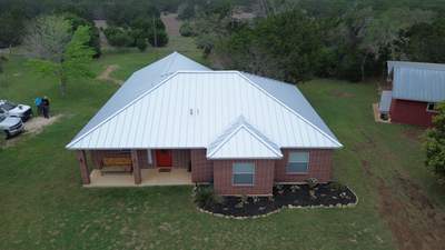 Standing seam metal roof on a red brick home