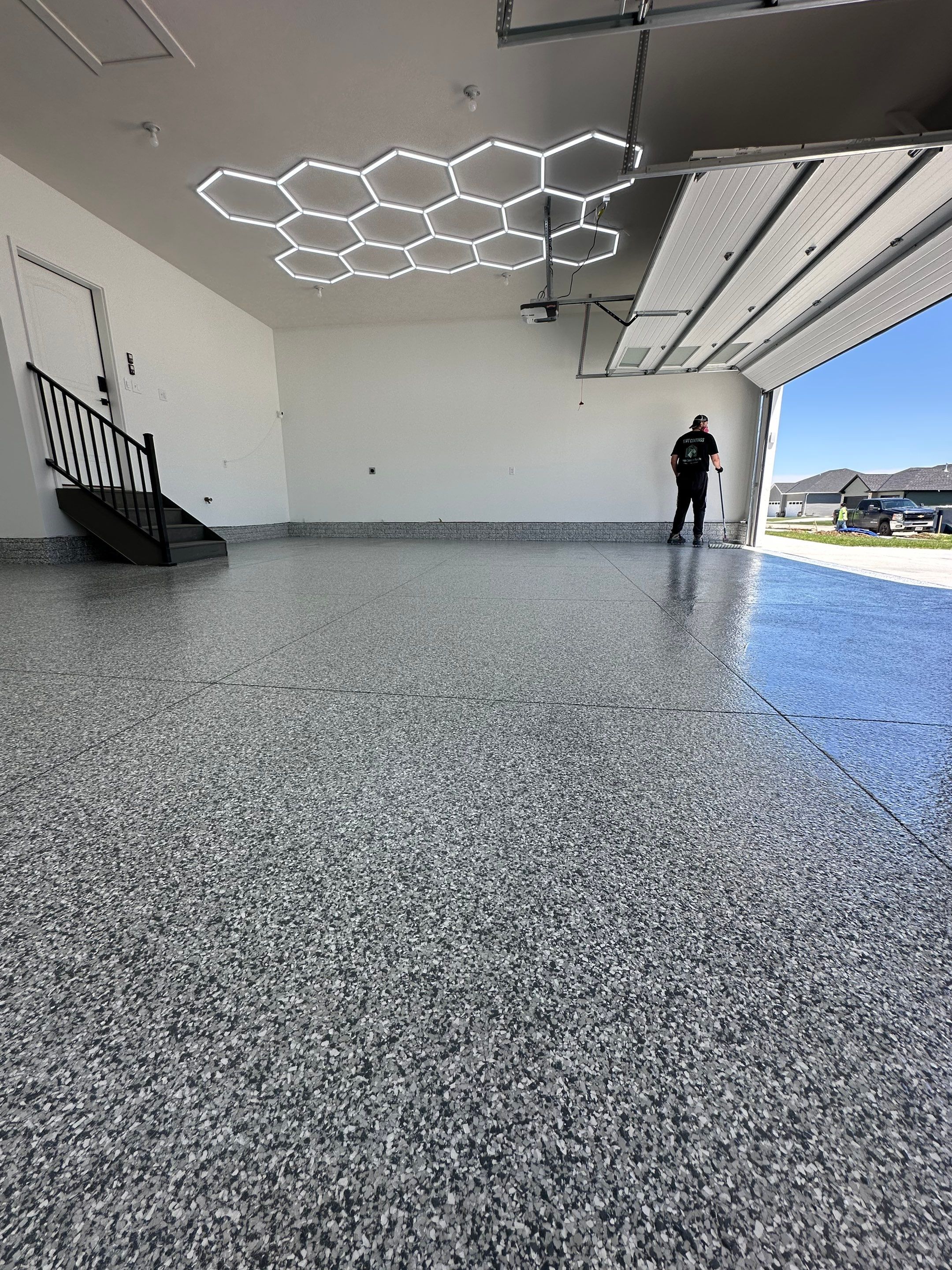 Three-Stall Garage Epoxy Floor Coating and LED Lighting in Lincoln by Goat Coatings