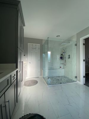 Master Bathroom Renovation Featuring Marble-Look Tile and Frameless Glass