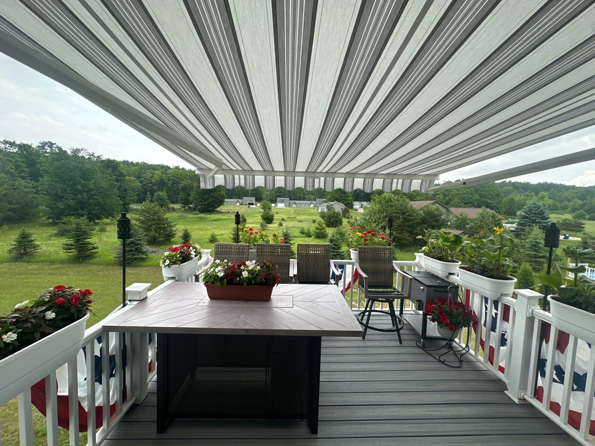 Sunesta Retractable Awning Installation Over Petoskey Home Deck by Rainbow Seamless Systems