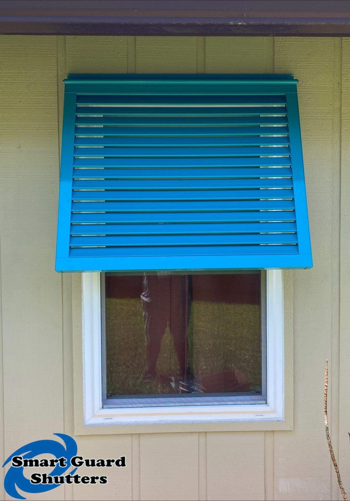 Decorative Bahama Shutters in Turquoise Blue  by Smart Guard Shutters