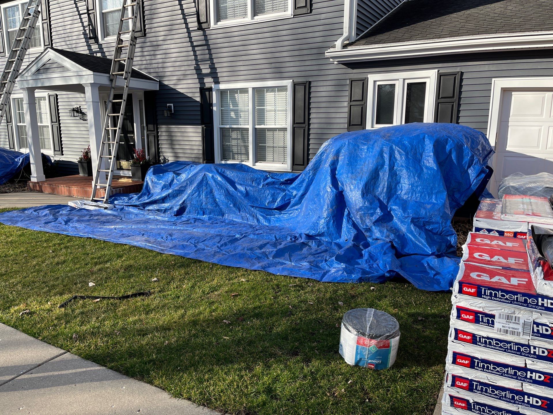Asphalt Roof Replacement with Aluminum Gutter Installment by Custom Installations