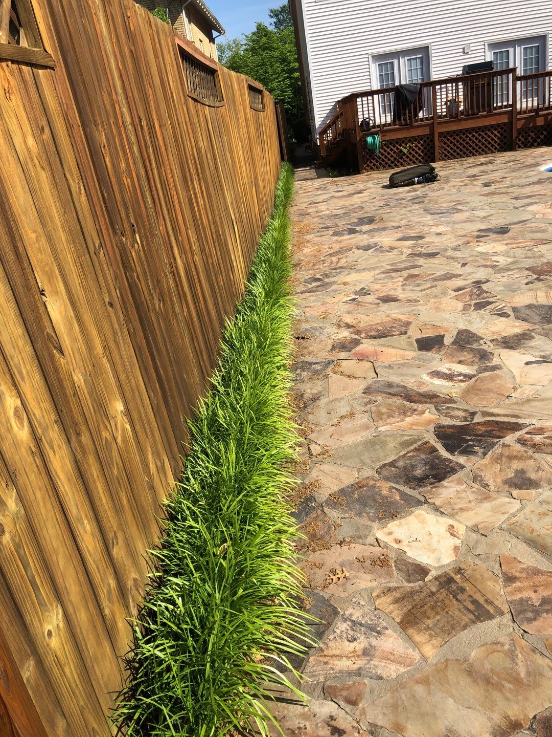 Liriope grasses, mulch and stone pavers by GrassBusters, Inc.