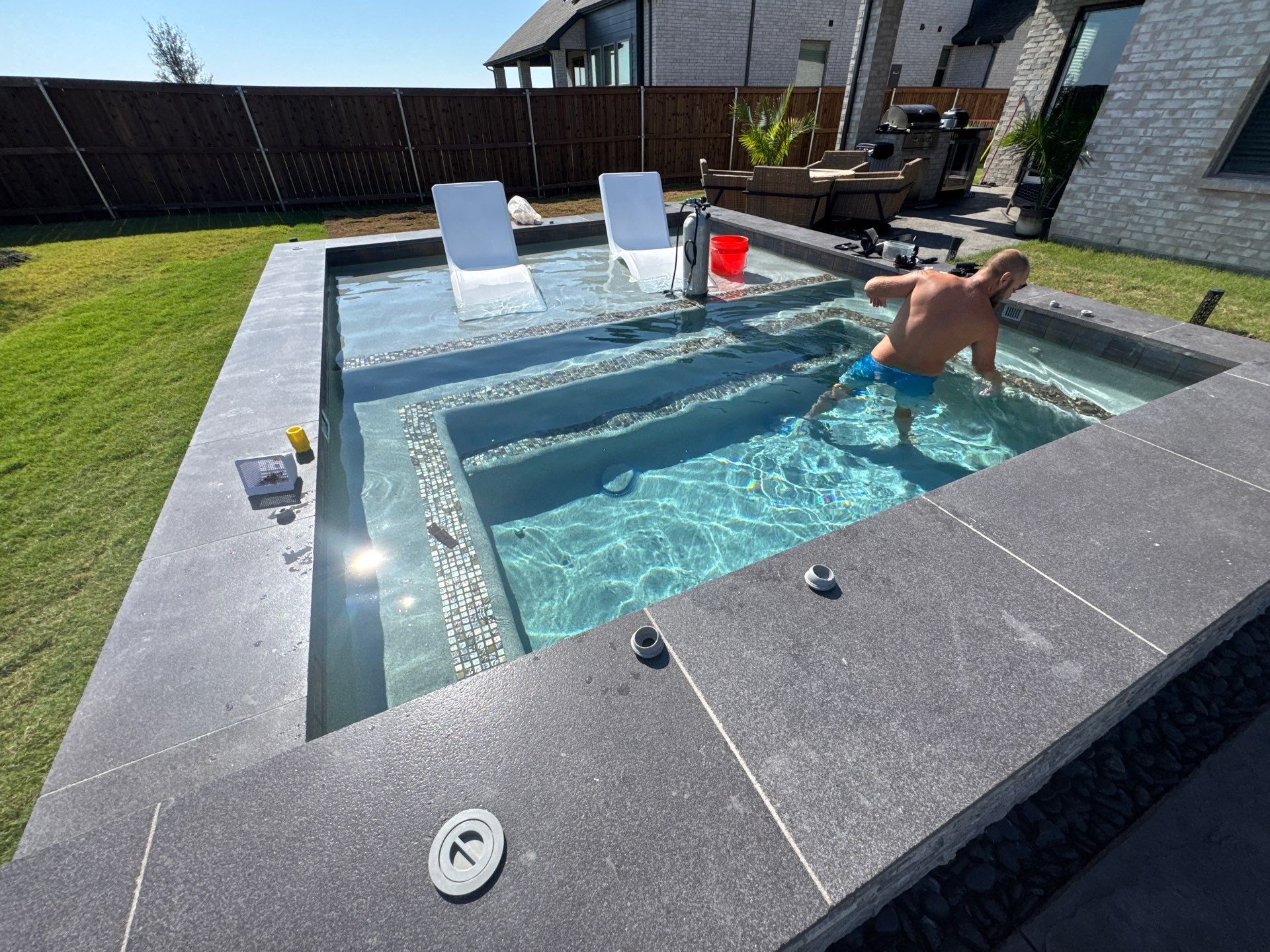Modern Spool with Tanning Ledge and In-Water Loungers by Pinnacle Pools and Spas - DFW