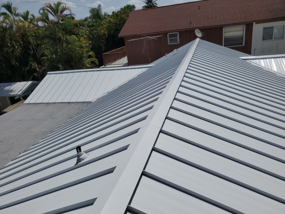 Residential Roofing Installation using 1.5" Nail Strip 24ga Solar White Kynar Coated Standing Seam Metal Panels by Morton Roofing, Inc.