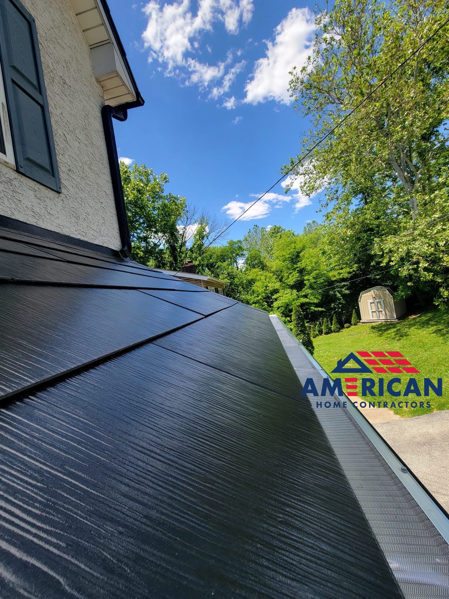 Tesla Solar Roof, Powerwall, and Black Gutters by American Home Contractors