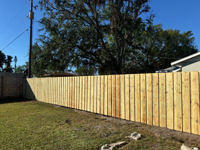 Wood Fence Installation using 6Ft Pressure Treated Wood Board On Board Privacy Fence