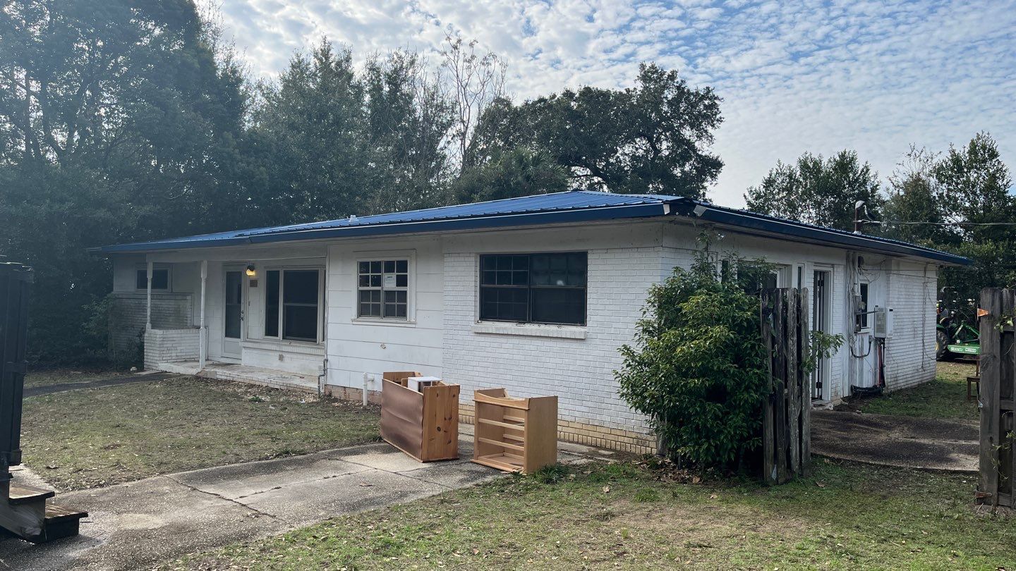 White Seamless Gutters and Black Downspouts by Gutter Professors