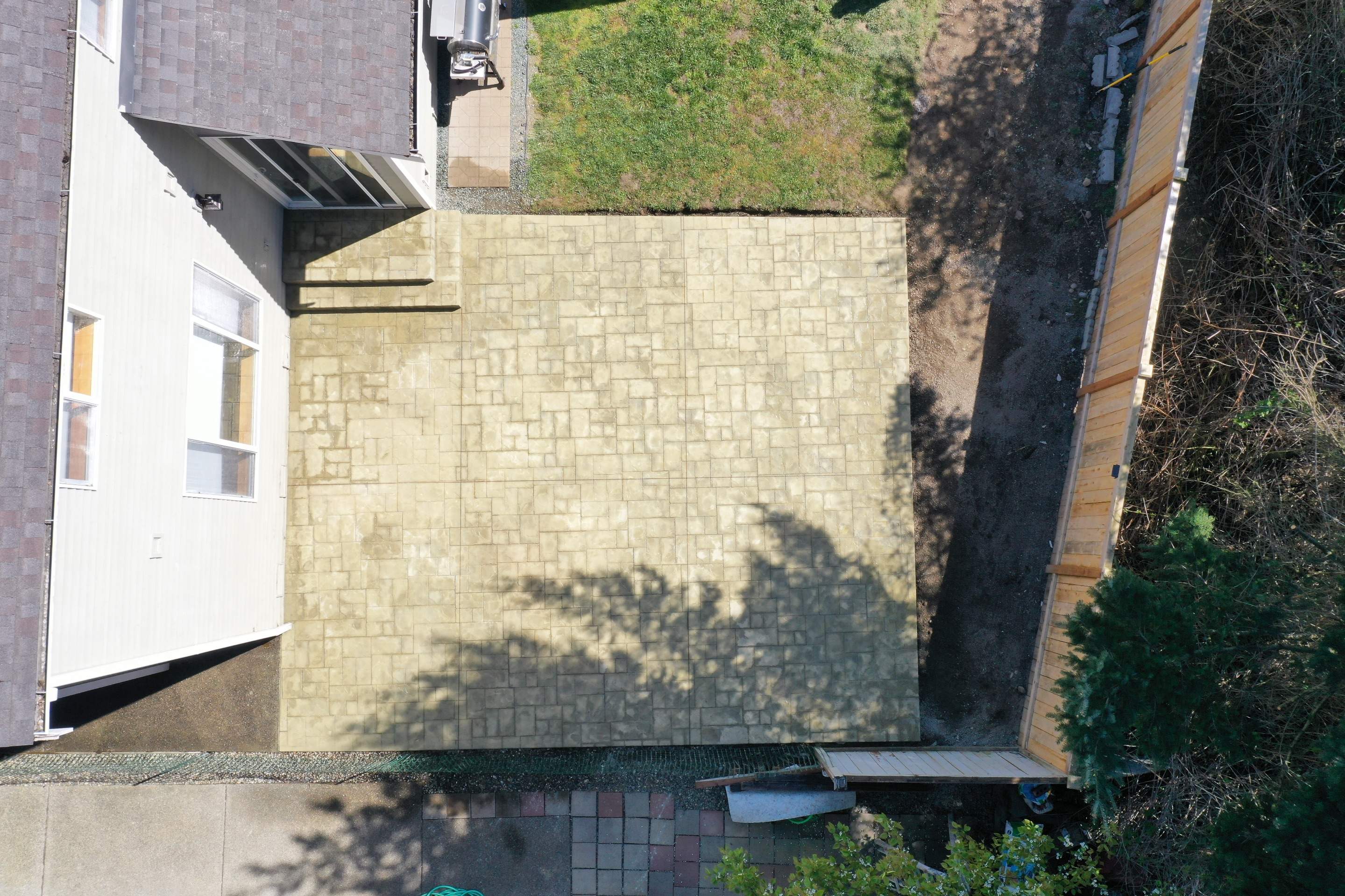 Benedict | Stamped Concrete Back Patio by Jireh Asphalt & Concrete Inc 