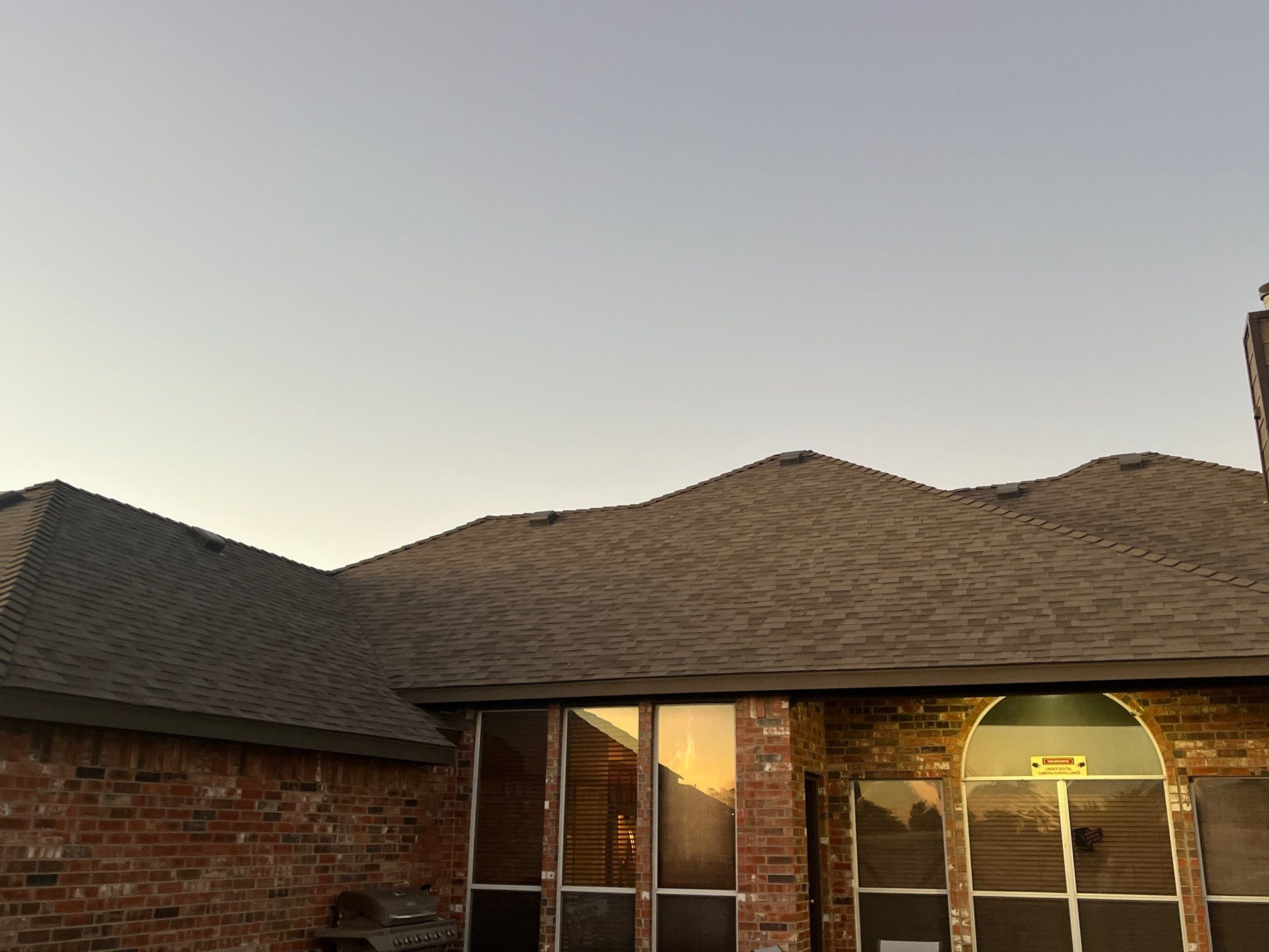 Brick with Malarkey Natural Wood by Tejas Roofworks + Restoration