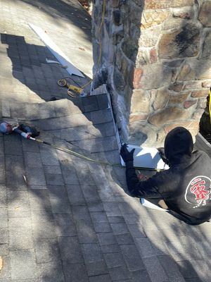 Insurance repair and chimney saddle installation.