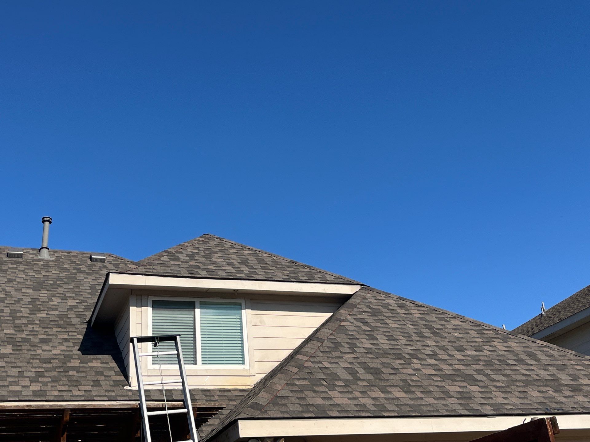 IKO Cornerstone-Dark Reddish Brown brick house  by Tejas Roofworks + Restoration