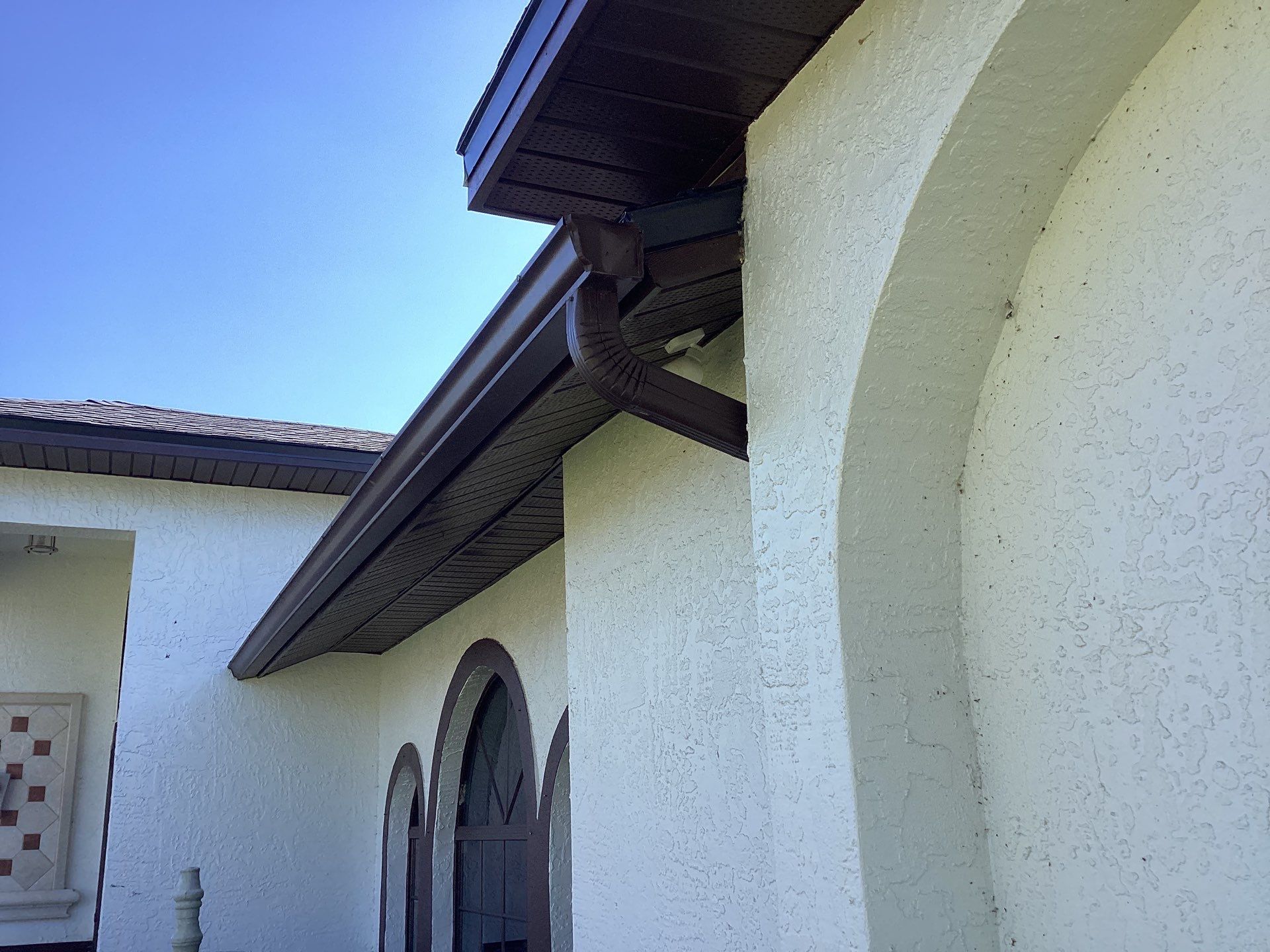 Brown Gutter + White and Brown Downspouts in Cape Coral FL by Gutter Professors