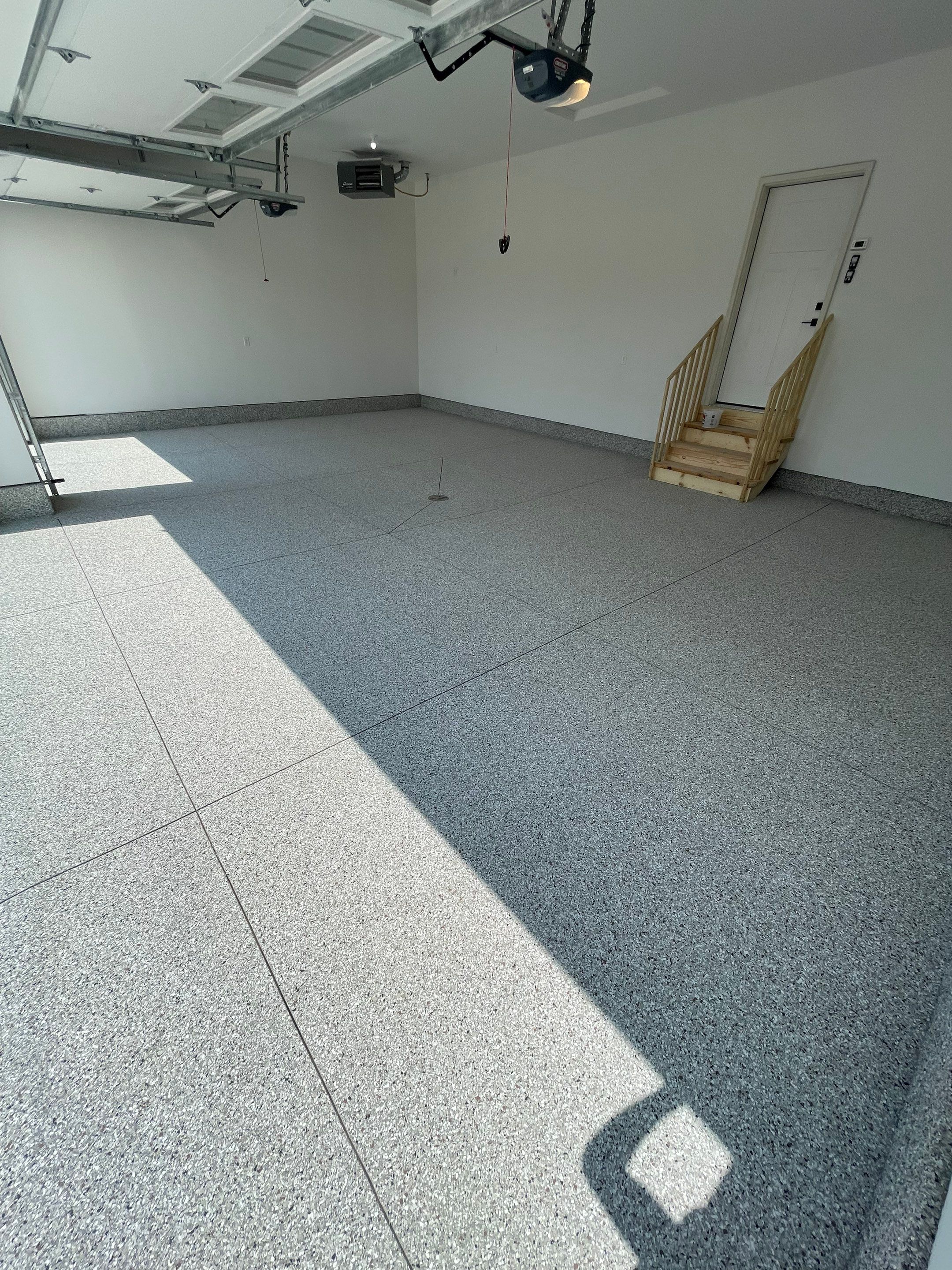 Grey Speckled Garage Floor Coating in Sioux Falls by Select Painting, Coatings & Garage Cabinets