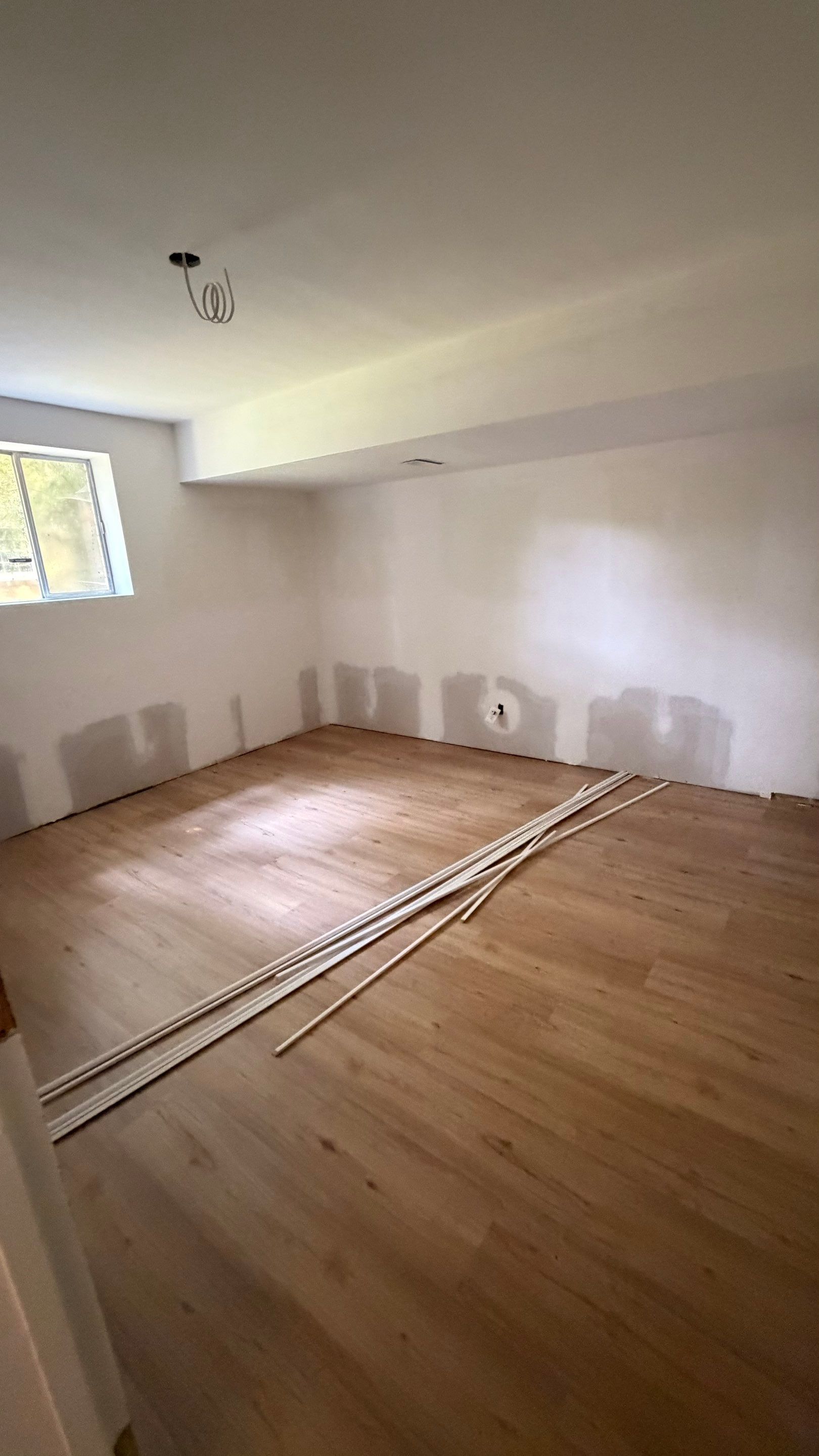 Basement Remodeling with Wood-Look Flooring and Custom Wainscoting in Dunwoody by Swift Home Renovations