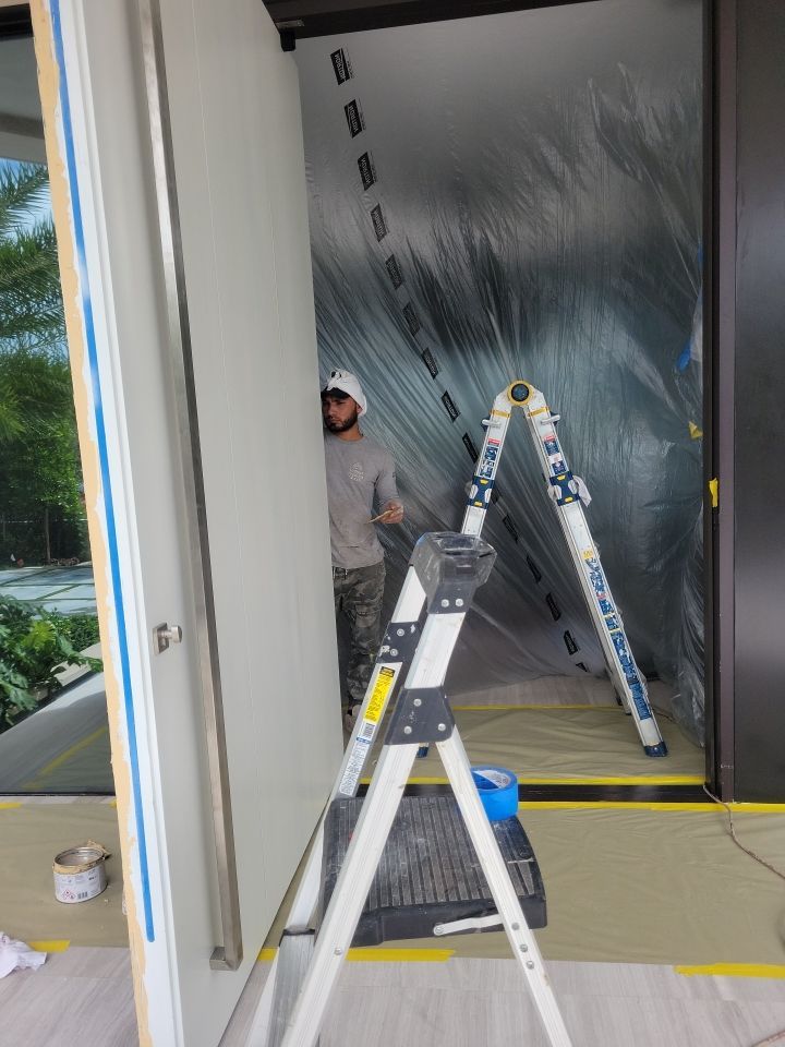 Custom Material Pivot Door installation by Impact Precious Wood Inc.