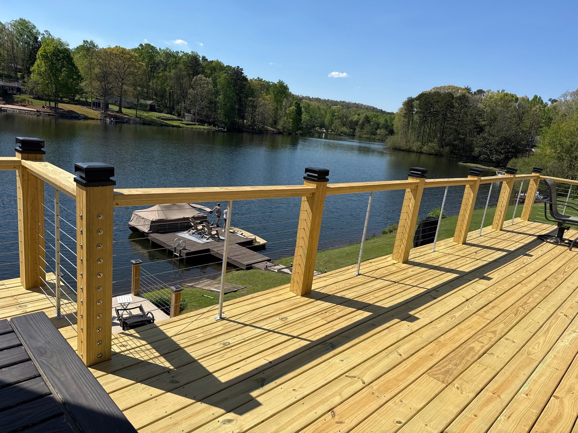 Cumming, GA Lake House Deck Resurface and Extension using Pressure Treated Pine and Skyline Cable Railing by Nelson Exteriors 