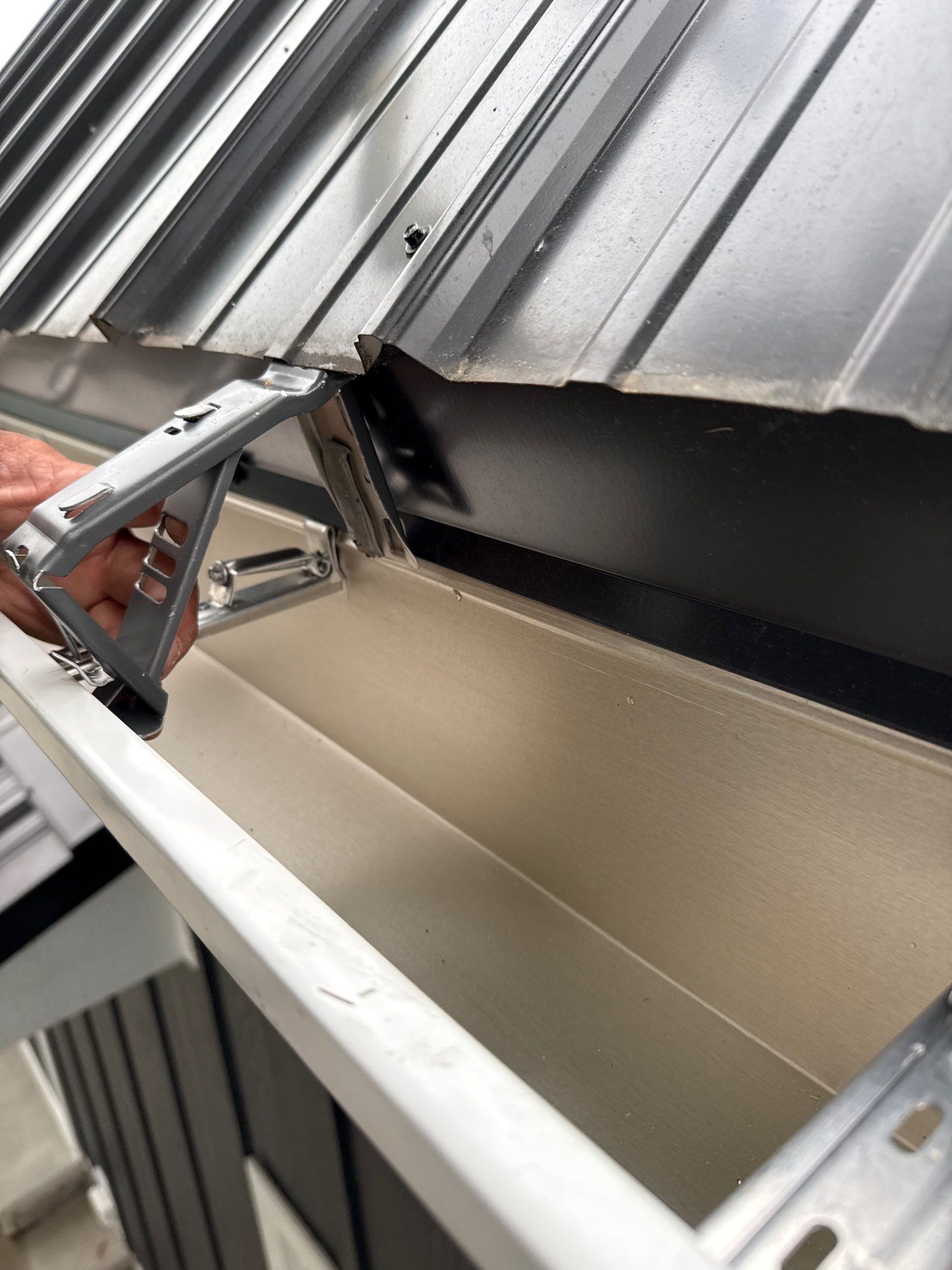 Seamless Gutter and Gutter Helmet Installation on Bellaire Metal Roof by Rainbow Seamless Systems