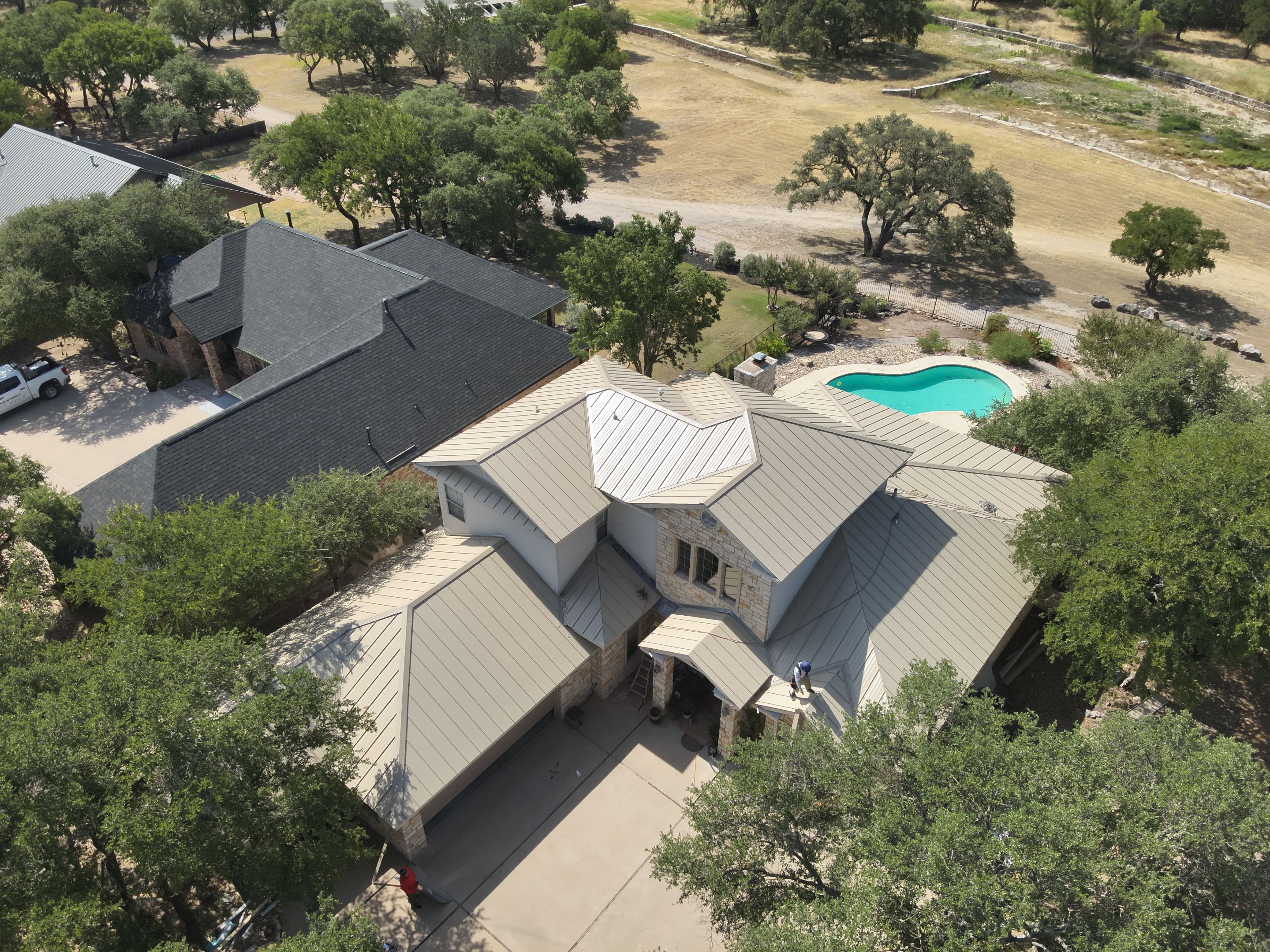 Residential Roof Replacement using 24 GA Double-Lock - Surrey Beige by Action Exteriors Austin