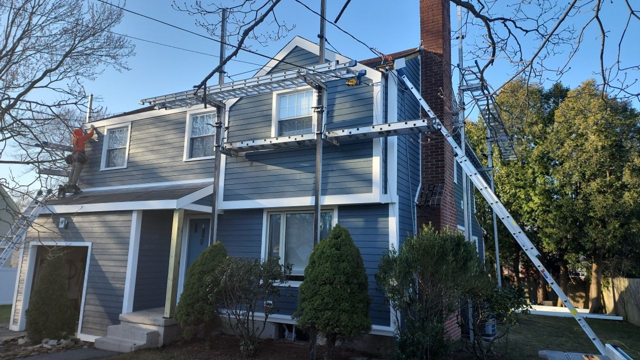 James Hardie siding, new metal roof and couple windows being installed. by UBrothers Construction