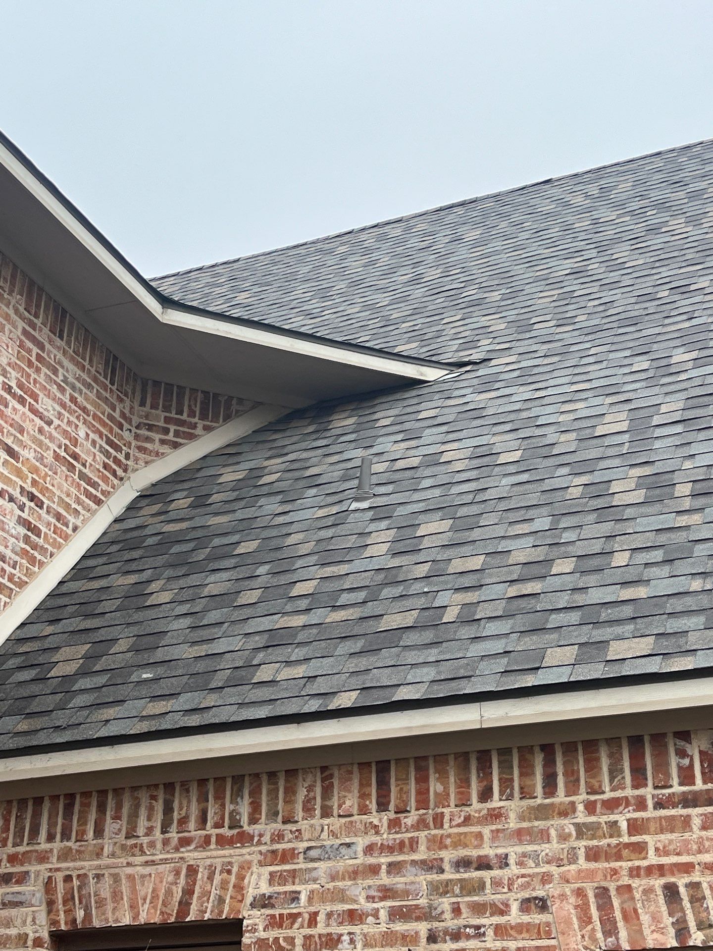 Light red brick/cream stone/espresso shutters with IKO Cornerstone by Tejas Roofworks + Restoration