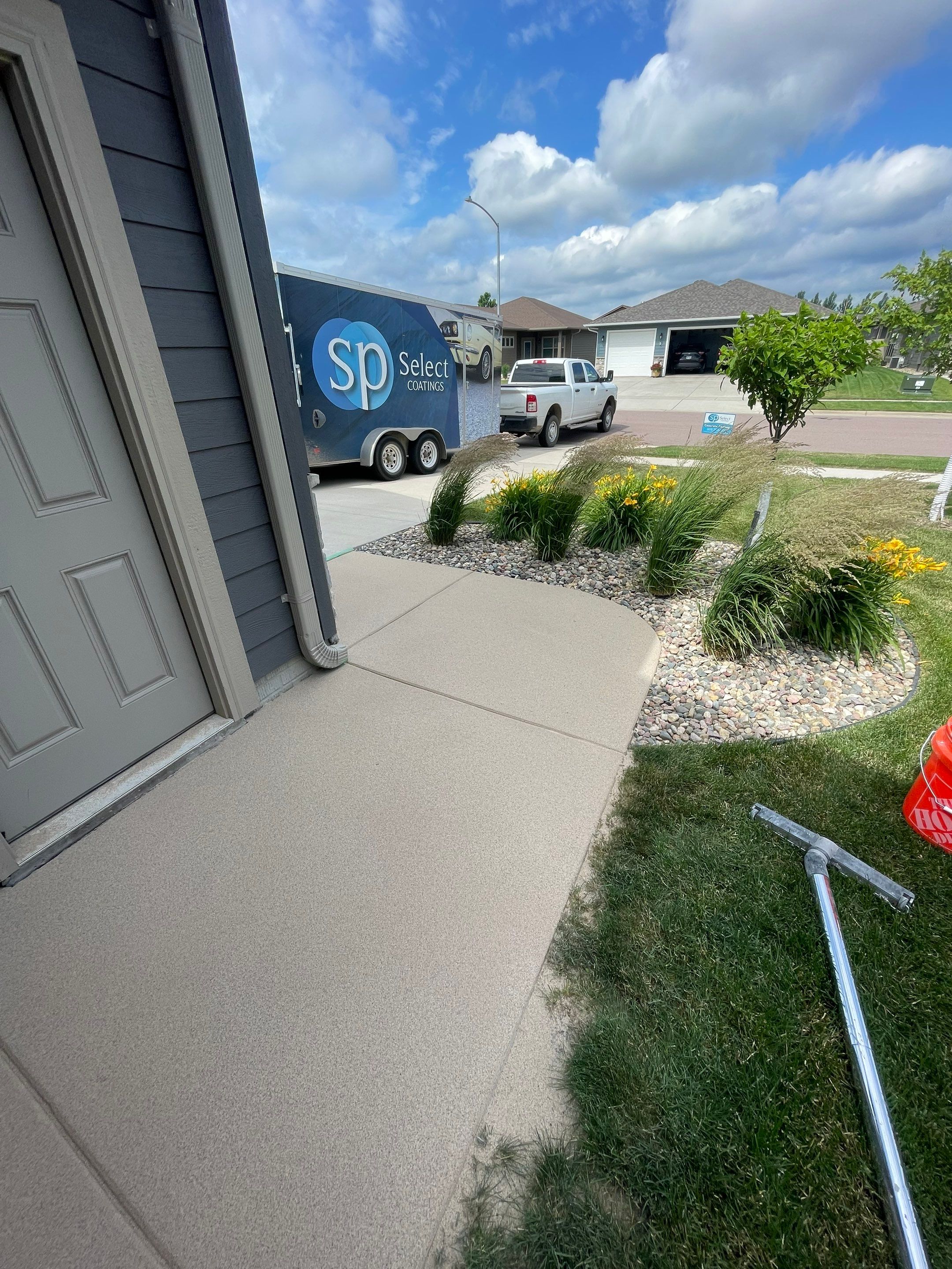 Textured Concrete Patio Coating and Custom Privacy Pergola in Sioux Falls by Select Painting, Coatings & Garage Cabinets