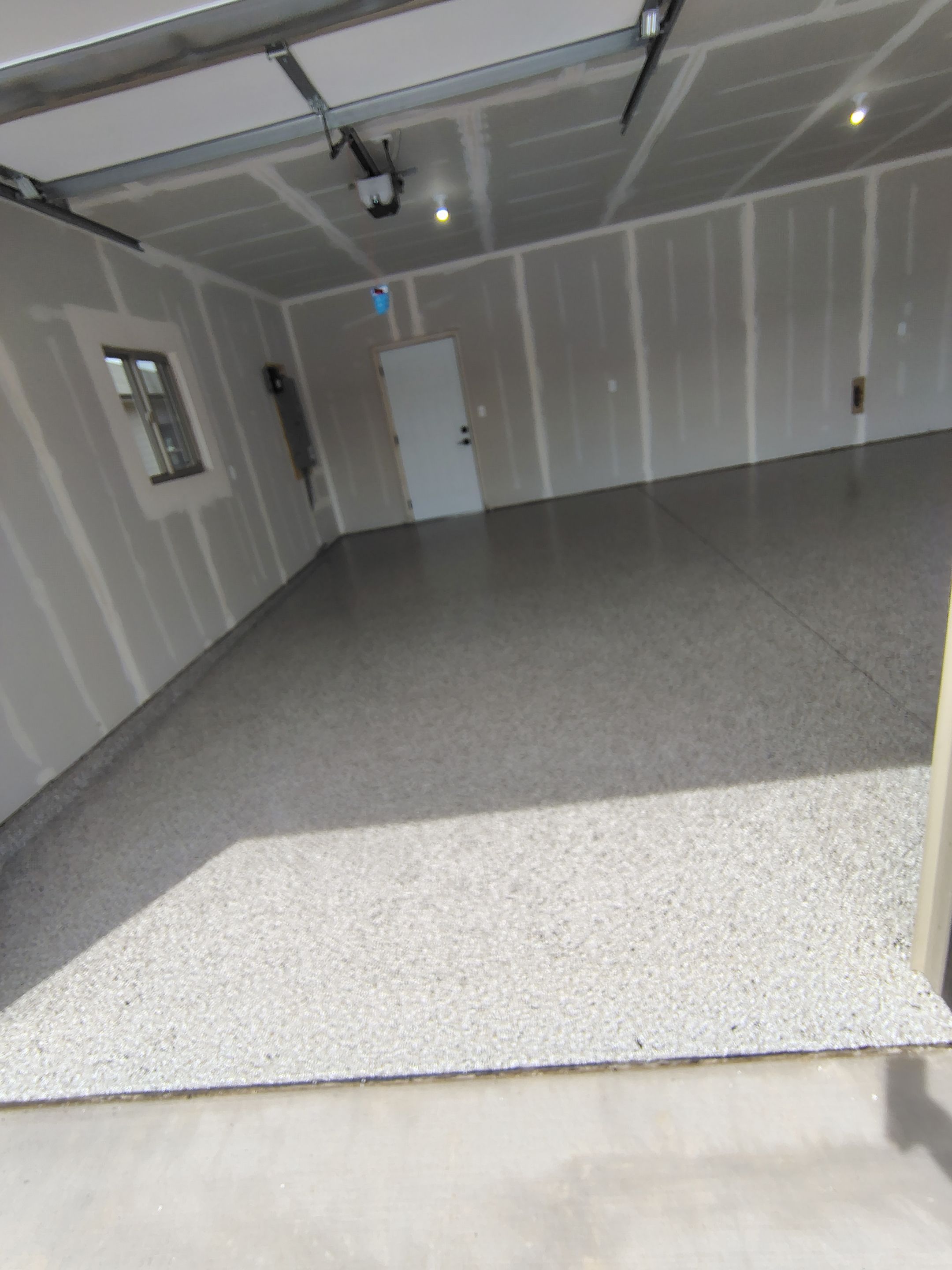 Speckled Epoxy Garage Floor Coating Installation in Sioux Falls by Select Painting, Coatings & Garage Cabinets