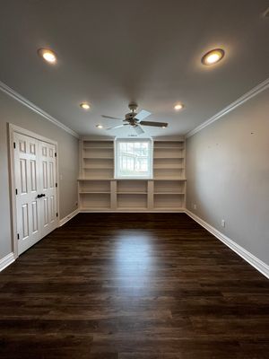 Finished Basement Remodeling with Dark Wood-Look Flooring and Custom Wainscoting